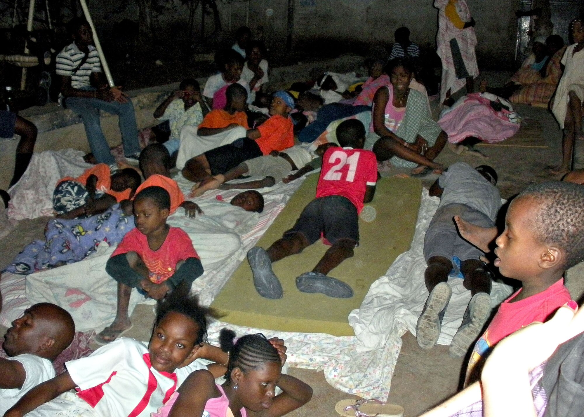 Children look for a place to sleep following a devastating earthquake in Port-au-Prince, Haiti. Airman 1st Class Mike Cooksey, 27th Special Operations Equipment Maintenance Squadron, returned to Cannon Air Force Base, N.M., Jan. 17, 2010, from Haiti where he had gone on leave to help a friend who was there on a mission. (Courtesy photo/Airman 1st Class Mike Cooksey)             
