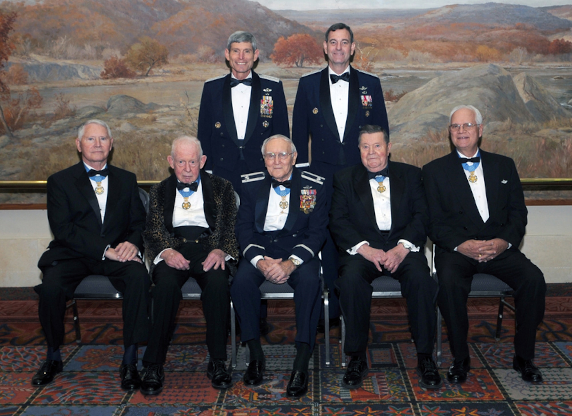 Gen. Norton A. Schwartz, Air Force chief of staff, and Gen. Stephen R. Lorenz, Commander of Air Education and Training Command, pose with the five living Air Force Medal of Honor recipients shortly before the 2010 AETC Symposium Ball Jan. 15. The CSAF honored (seated left to right) Cols. Leo K. Thorsnesss, Bernard F. Fisher, George E. "Bud" Day, Joe M. Jackson and James P. Fleming at the dinner, citing that these humble heroes are quick to say they did what anyone else would do in the service of their nation and that they believe they wear the medal for others who cannot. Earlier that day, the five recipients shared their stories and talked about courage, character and commitment with about 2,000 Airmen attending the two-day AETC Symposium.  (U.S. Air Force photo/Don Lindsey)