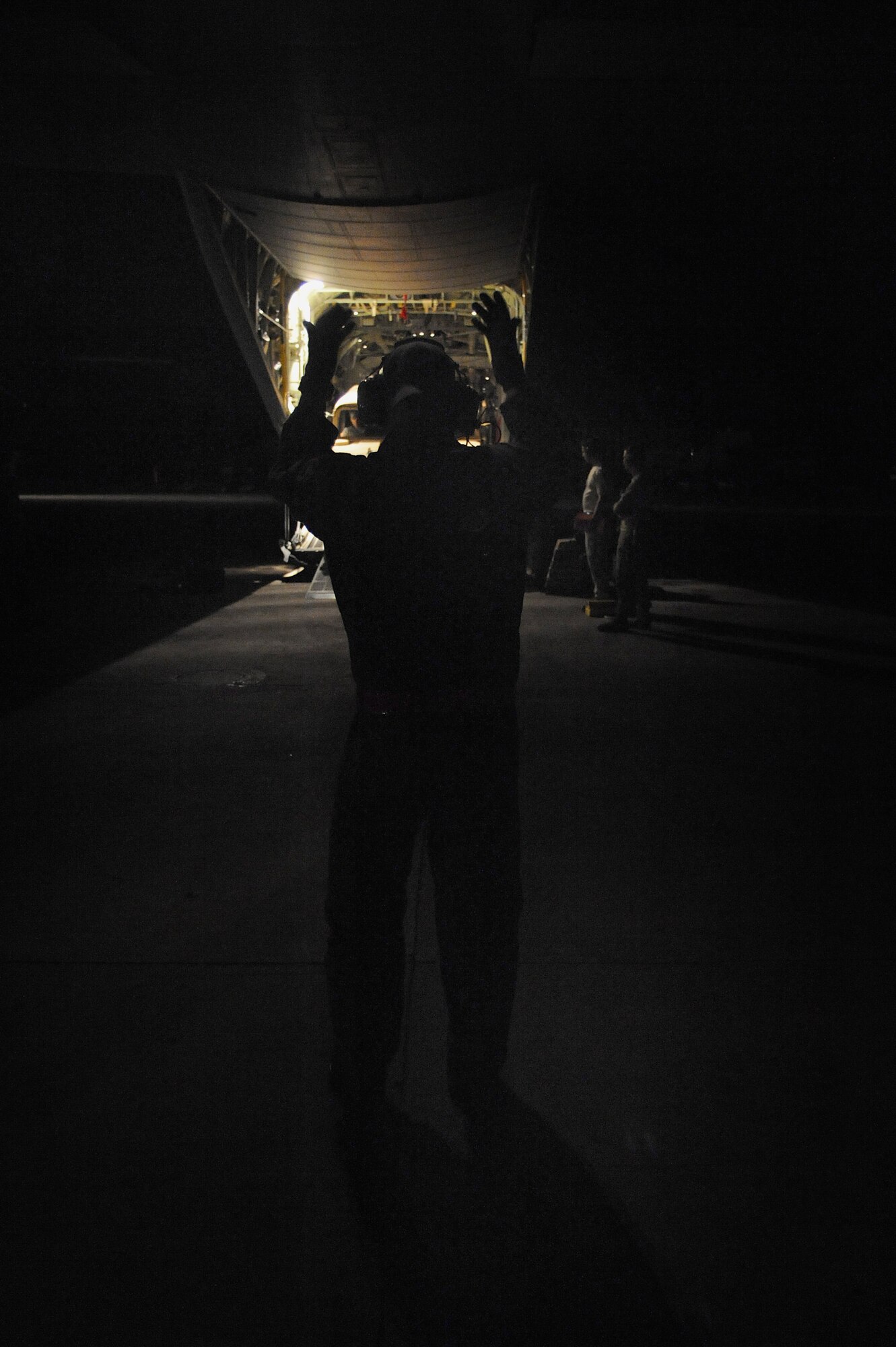 U.S. Air Force Tech. Sgt. Charles Moore, 41st Airlift Squadron loadmaster stationed at Little Rock Air Force Base, Ark., signals an 82nd Airborne Division Humvee driver to drive his vehicle out the back of a C-130J Hercules at the Port-au-Prince International Airport, Haiti, Jan. 20, 2010.  Sergeant Moore is assisting in earthquake relief efforts as part of Operation Unified Response, transporting personnel, equipment and supplies. (U.S. Air Force photo/Staff Sgt. Chad Chisholm)
