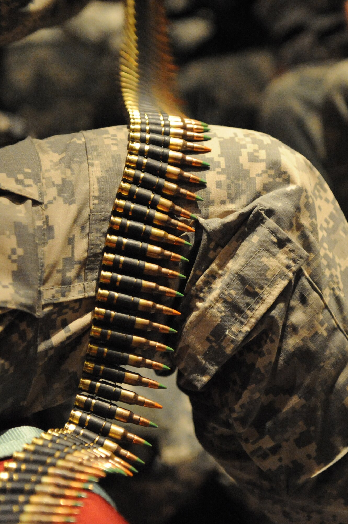 U.S. Army Spc. Ralph Libby, 82nd Airborne Division infantry, uses his knee to keep an ammo belt for a Squad Automatic Weapon, M249 Light Machine steady and straight will he feeds the ammo into a ammo pouch at MacDill Air Force Base, Fla., Jan. 19, 2010. Spc. Libby and other Soldiers from the 82nd Airborne will be supporting the earthquake relief during the earthquake relief efforts in support of Operation Unified Response. (U.S. Air Force photo/Staff Sgt. Chad Chisholm)