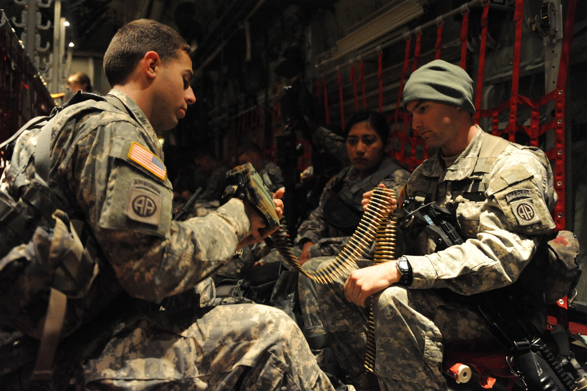 U.S. Army Spc. Ralph Libby (right) and Sgt. Timothy Hoff, 82nd Airborne Division infantry, load a Squad Automatic Weapon, M249 Light Machine Gun pouch with a 200mm round disintegrating belt holding the 5.56mm cartridge rounds during a stop at MacDill Air Force Base, Fla., Jan. 19, 2010.  Spc. Libby and Sgt. Hoff will be conducting security and humanitarian support during earthquake relief efforts in support of Operation Unified Response. (U.S. Air Force photo/Staff Sgt. Chad Chisholm)