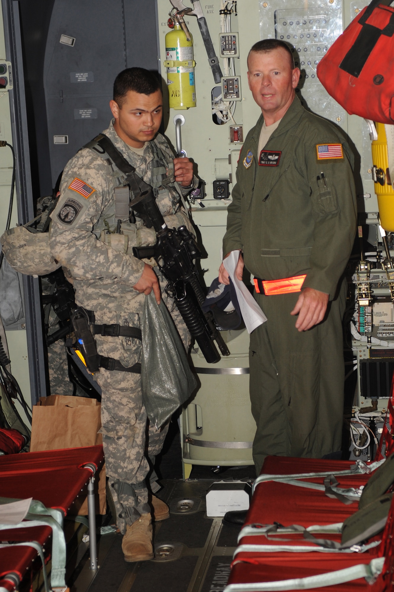 U.S. Air Force Tech. Sgt. Charles Moore, 41st Airlift Squadron loadmaster stationed at Little Rock Air Force Base, Ark., ensures Army Sgt Benjamin Hernandez, 65th Military Police Co. Airborne, along with other soldiers from the 82nd Airborne from Ft. Bragg, N.C., are properly seated in the troop seats on a C-130J Hercules at Pope Air Force Base, N.C., Jan. 19, 2010.  Little Rock AFB is a component of Air Mobility Command. Since Jan. 13, AMC has delivered more than 1,600 tons of supplies to the region as part of Operation Unified Response. AMC aircraft and personnel continue to support the international effort to increase the velocity with which aid is flowing to those in need. (U.S. Air Force photo/Staff Sgt. Chad Chisholm) 
