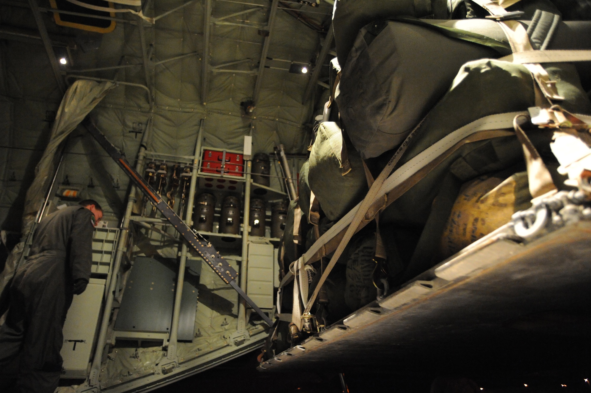 A pallet full of military equipment is loaded onto the back of a C-130J Hercules assigned to the 41st Airlift Squadron at Little Rock Air Force Base, Ark., as Air Force Staff Sgt. Lynzey Thorton, 41st AS loadmaster, checks to make sure the position of the pallet is correctly aligned at Pope Air Force Base, N.C., Jan. 19, 2010.  Little Rock AFB is a component of Air Mobility Command. Since Jan. 13, AMC has delivered more than 1,600 tons of supplies to the region as part of Operation Unified Response. AMC aircraft and personnel continue to support the international effort to increase the velocity with which aid is flowing to those in need. (U.S. Air Force photo/Staff Sgt. Chad Chisholm) 