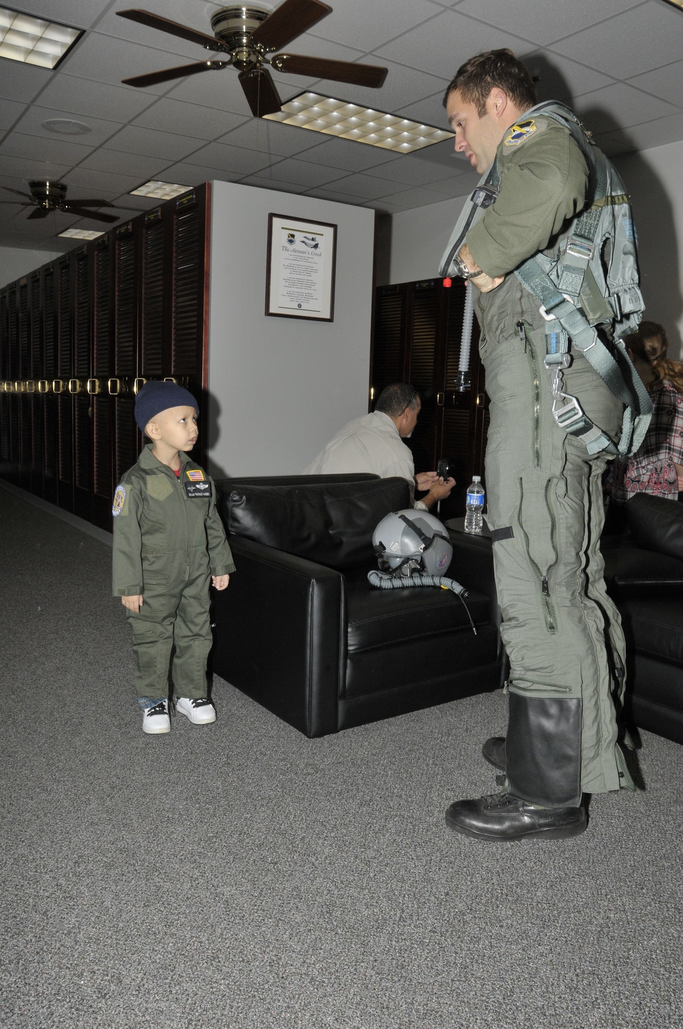 Capt. John Hensz, 43rd Fighter Squadron Instructor Pilot, shows Dylan Hardee, a child in the Make-A-Wish program, how to put on his pilot gear.  (U.S. Air Force photo/Lisa Norman)