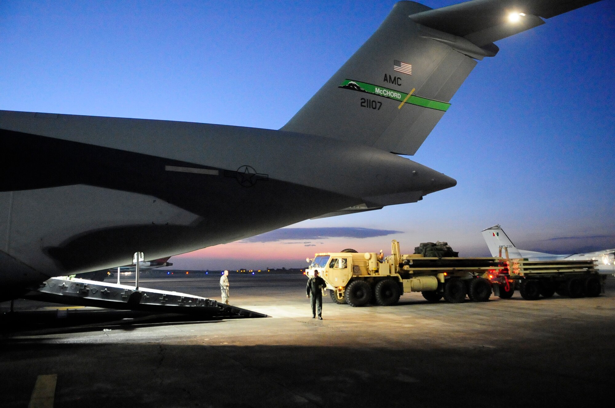 A vehicle used to assist in loading and off-loading is backed out of a McChord C-17 at Port-Au-Prince's Toussaint L’Ouventure International Airport in Haiti Sunday. The McChord aircrew transported nearly 179,000 pounds of supplies and equipment to the earthquake striken island from Langley AFB, Va. Sunday. (U.S. Air Foce Photo/Master Sgt. Chris Haylett)