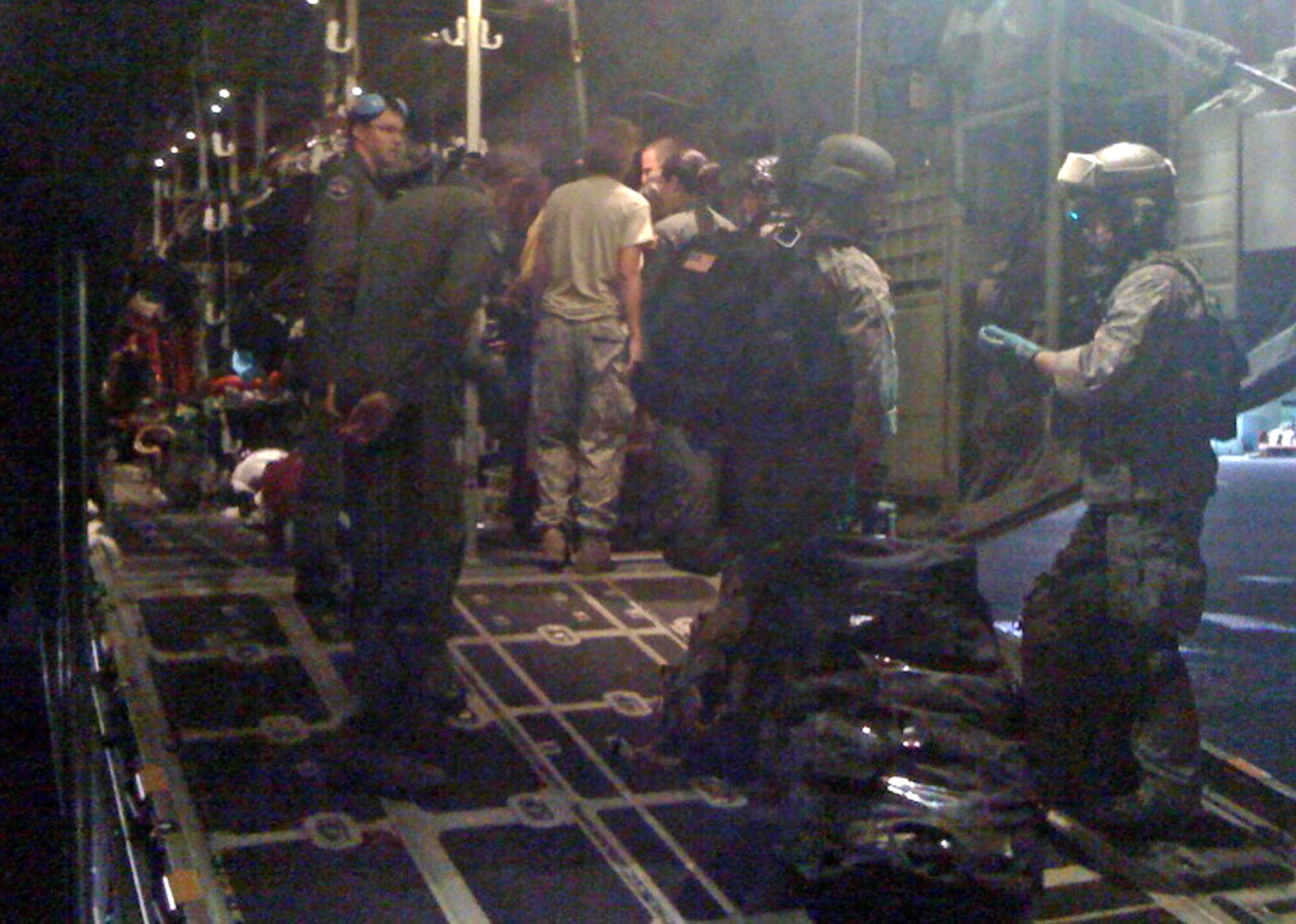 Military medics and C-130 Hercules aircrew members from the Air Force Reserve's 302nd Airlift Wing finalize plans to transport evacuees during the early morning hours of Jan. 17, 2010, at Toussaint L'Ouverture International Airport in Port-au-Prince, Haiti. The C-130 aircrew, based at Peterson Air Force Base, Colo., transported the injured Haitians to Fort Lauderdale, Fla., where they received additional medical treatment. (U.S. Air Force photo/Capt. Brian McReynolds)