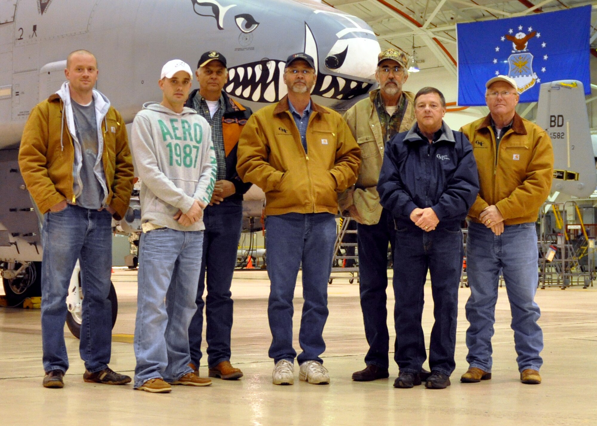 A group of civilian contractors working out of Claiborne Range take a break from their tour of Barksdale Air Force Base, La., to gather for a group photo on Jan. 13, 2010. Claiborne Range, located three hours South of Barksdale, is used by the 47th Fighter Squadron on Barksdale as an air-to-ground gunnery range for A-10 Thunderbolt II training. Some of the contractors working on Claiborne Range have never seen the aircraft up close during their 20 years there. (U.S. Air Force Photo/Senior Airman Crystal Marie Jordan)