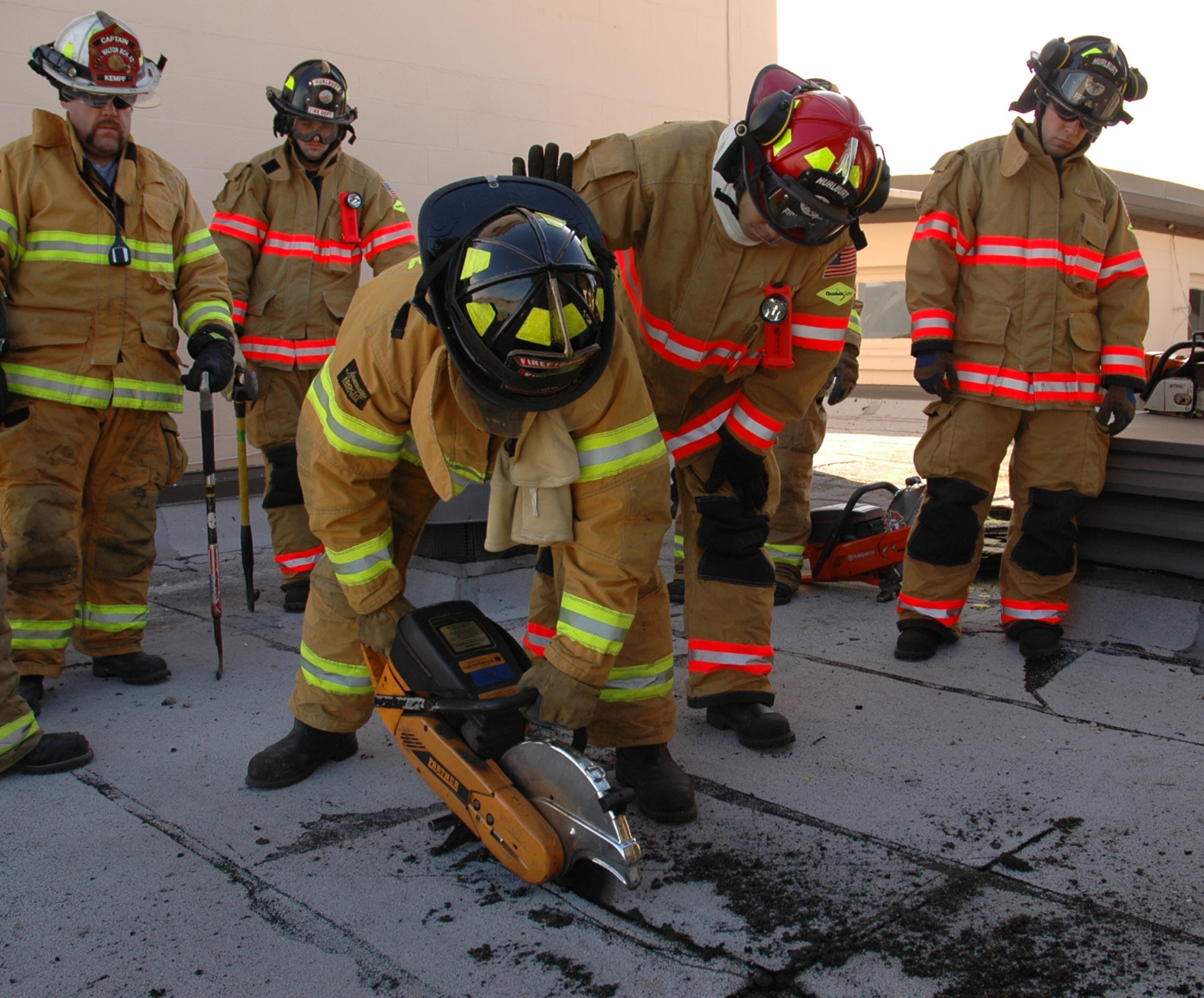 Firefighters from Hurlburt Field and surrounding counties use a circular saw to cut sections of the roof of the old base Fire Department Jan. 13. The Okaloosa County Joint Training Council session took place in the old station weeks before it will be demolished. (U.S. Air Force photo by Airman 1st Class Joe McFadden)
