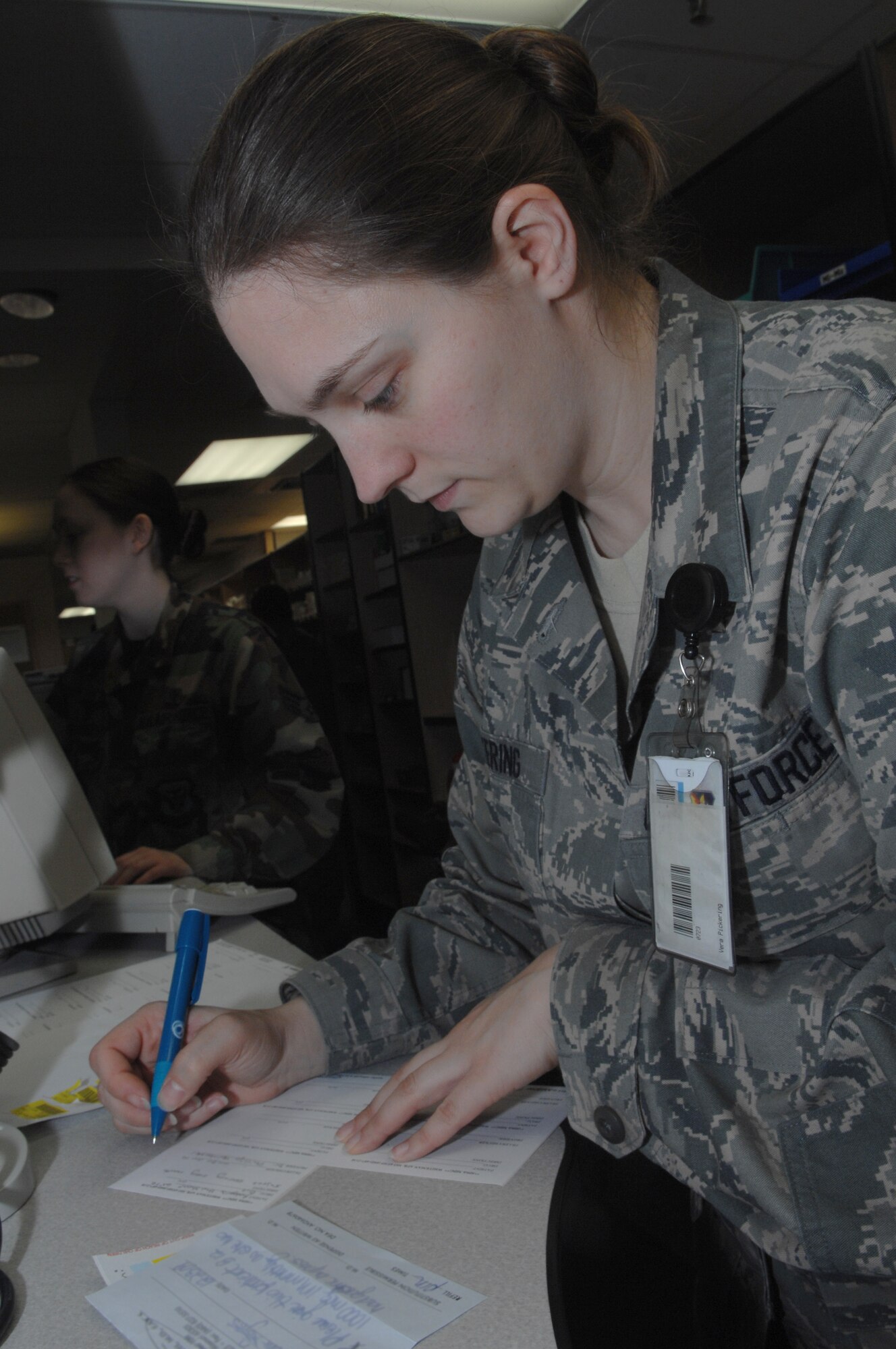 WHITEMAN AIR FORCE BASE, Mo., - Staff Sgt. Vera Pickering, 509th Medical Group pharmacy technician, fills a patient's prescription by hand during a power-outage here Jan. 20, 2010. Hand-writing a prescription is part of the pharmacy's back-up contingency plan, if their computers become unavailable, in order to keep their mission going uninterrupted. The Whiteman Pharmacy fills 350-700 prescriptions daily. (U.S. Air Force photo/Senior Airman Jessica Mae Snow) (Released)