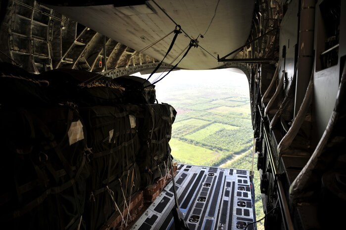 Pallets of relief supplies exit a C-17 Globemaster III cargo aircraft over Haiti Jan. 18, 2010. The C-17, crewed by Airmen from the 437th Airlift Wing at Charleston Air Force Base, S.C., departed Pope AFB, N.C., and delivered 40 pallets of food and water into Haiti. Joint Task Force-Haiti secured an area in which to air deliver the supplies. Once on the ground, supplies were distributed by JTF-Haiti, the U.S. Agency for International Development and other relief personnel. (U.S. Air Force photo by Master Sgt. Shane A. Cuomo/Released)