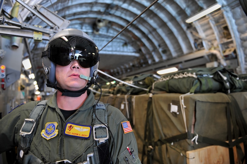 Air Force Tech. Sgt. Aaron Avery prepares to release pallets of relief supplies from a C-17 Globemaster III cargo aircraft for a humanitarian air delivery over Haiti Jan. 18, 2010. The C-17 and crew conducted the first humanitarian air delivery to be flown in support of Operation Unified Response, sending more than 69,000 pounds of supplies into Haiti. Avery is a loadmaster from the 16th Airlift Squadron at Charleston Air Force Base, S.C. (U.S. Air Force photo by Master Sgt. Shane A. Cuomo/Released)