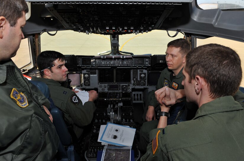 Air Force pilots from the 16th Airlift Squadron at Charleston Air Force Base, S.C., conduct a preflight briefing on their C-17 Globemaster III cargo aircraft Jan. 18, 2010, at Pope Air Force Base in Fayetteville, N.C., before taking off for a humanitarian mission to Haiti. The C-17 conducted the first humanitarian air delivery mission over Haiti to test the feasibility of future missions in speeding along the flow of supplies into the country. (U.S. Air Force photo by Master Sgt. Shane A. Cuomo/Released)