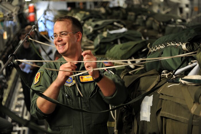 Tech. Sgt. Aaron Avery attaches de-oscillation ties to pallets of relief supplies aboard a C-17 Globemaster III cargo aircraft Jan. 18, 2010, at Pope Air Force Base in Fayetteville, N.C., before it takes off for a humanitarian mission in the vicinity of Port-au-Port, Haiti. Avery is a loadmaster from the 16th Airlift Squadron, Charleston Air Force Base, S.C. The C-17 and crew conducted the first humanitarian air delivery mission over Haiti. U.S. Southern Command is deploying assets to Haiti to conduct search and rescue operations, damage assessments and sustained humanitarian assistance and disaster relief operations. (U.S. Air Force photo by Master Sgt. Shane A. Cuomo/Released)