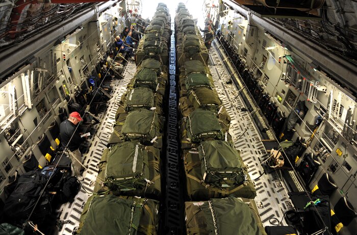 A C-17 Globemaster III cargo aircraft is loaded with 40 pallets of relief supplies Jan. 18, 2010, at Pope Air Force Base in Fayetteville, N.C., before taking off for a humanitarian mission to Haiti. The C-17, from Charleston Air Force Base in Charleston, S.C., conducted the first humanitarian air delivery mission over Haiti. U.S. Southern Command is deploying assets to Haiti to conduct search and rescue operations, damage assessments and sustained humanitarian assistance and disaster relief operations. (U.S. Air Force photo by Master Sgt. Shane A. Cuomo/Released)
