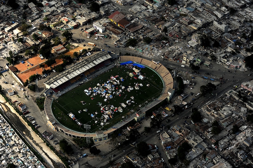 An aerial view shows downtown Port-au-Prince, Haiti, January 17, 2010. Makeshift shelters are being erected in open locations throughout the city in the aftermath of the devastating earthquake that struck the country Jan. 12, 2010. A Jan. 18 air delivery mission of supplies was directed at trying to find the most expedient method of deploying supplies to victims and relief workers. (DoD photo by Master Sgt. Jeremy Lock, U.S. Air Force/Released)