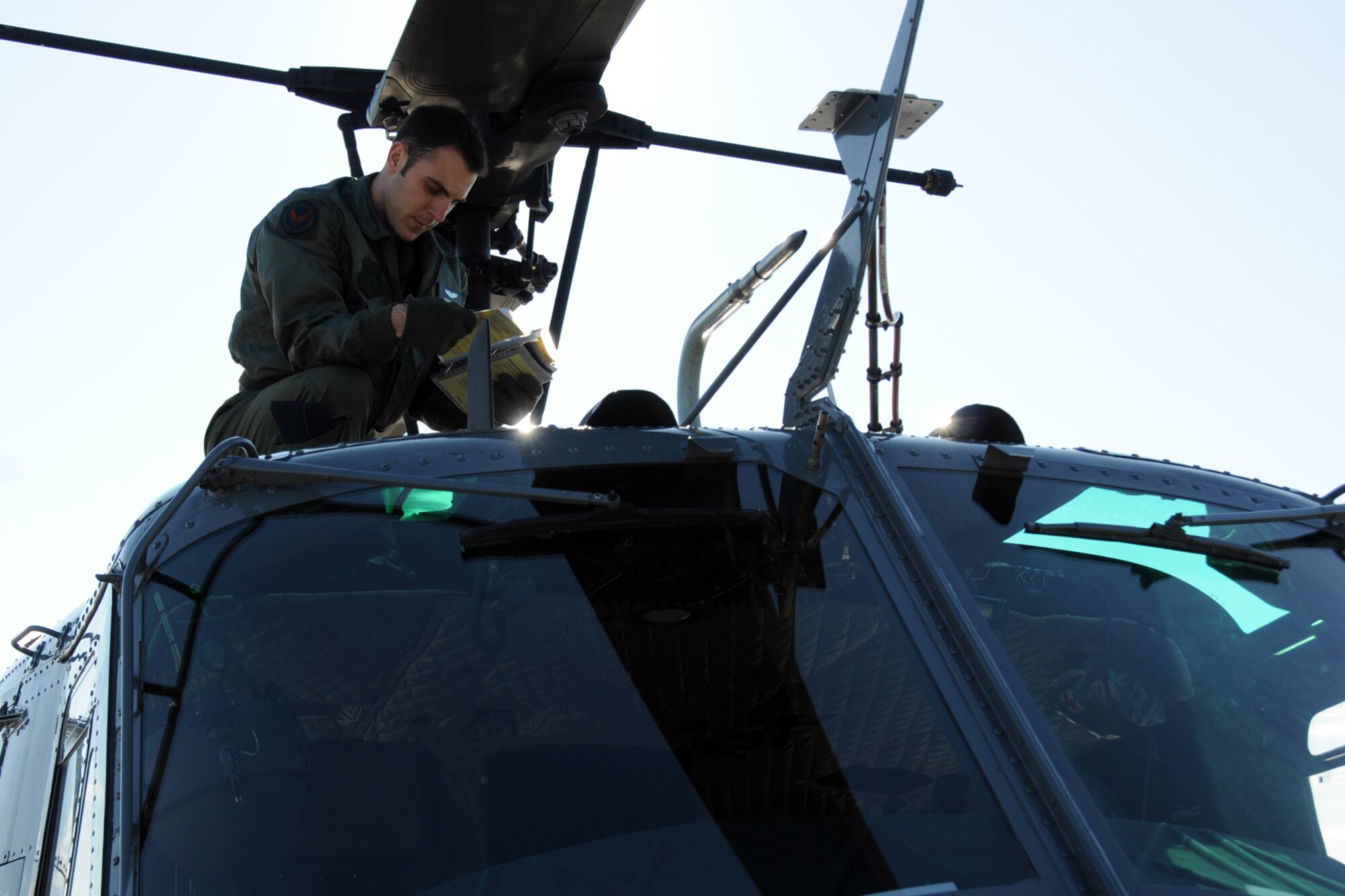 1st Lt. Michael Scott, a recent graduate from the 23rd Flying Training Squadron at Fort Rucker, Ala., checks his pre-flight inspection book before takeoff.  The 23rd FTS is the third and final phase of undergraduate pilot training before student helicopter pilots can obtain their wings.  It is the Air Force's primary source of helicopter pilot training for special operations, combat search and rescue, missile support and distinguished visitor airlift missions. (U.S. Air Force photo/Airman 1st Class Anthony Jennings)