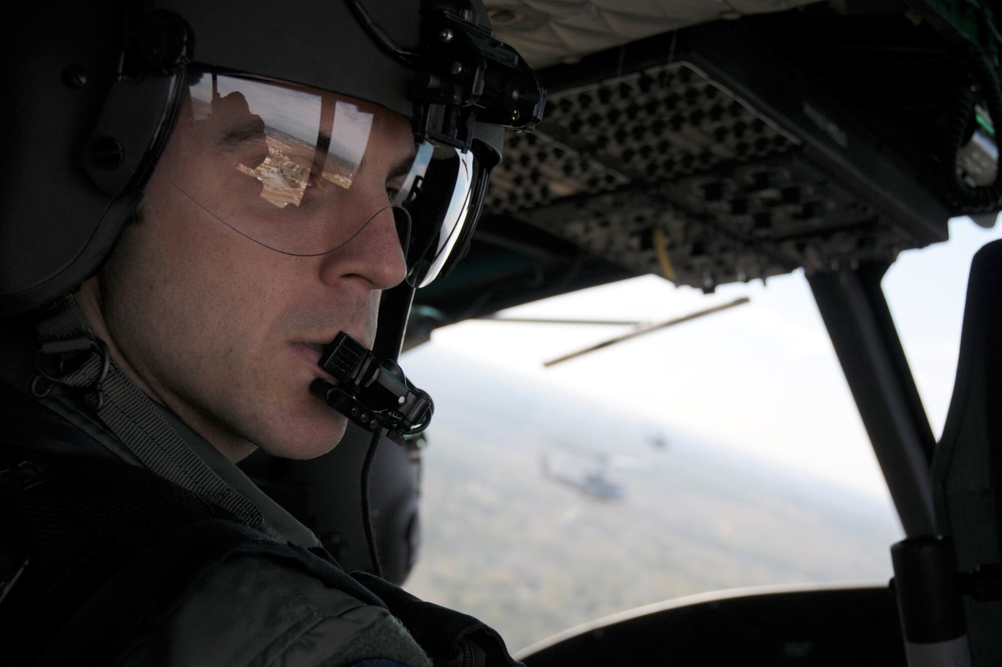 1st Lt. Michael Scott, a recent graduate from the 23rd Flying Training Squadron at Fort Rucker, Ala., checks his peripherals during a formation-flight mission.  The 23rd FTS is the third and final phase of undergraduate pilot training before student helicopter pilots can obtain their wings.  It is the Air Force's primary source of helicopter pilot training for special operations, combat search and rescue, missile support and distinguished visitor airlift missions. (U.S. Air Force photo/Airman 1st Class Anthony Jennings)