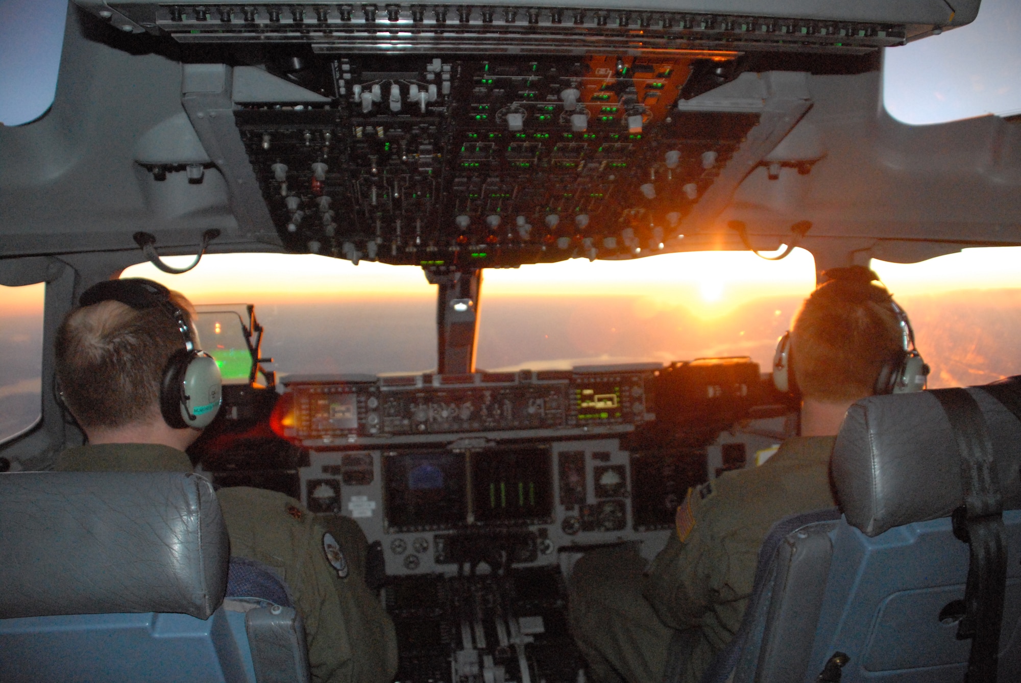 (Left) Maj. Mike Mundy, 326th Airlift Squadron mission pilot and Capt. Jim McCann, 326th AS aircraft commander, transport the Joint Communications Support Element to Port-au-Prince, Haiti, aboard a C-17 Globemaster III during the early morning hours of Jan. 16. The JCSE provides early entry communication support for the Regional Combatant Commands, Special Operations Command, and other U.S. agencies. (U.S. Air Force photo/2nd Lt Adam Gregory)
