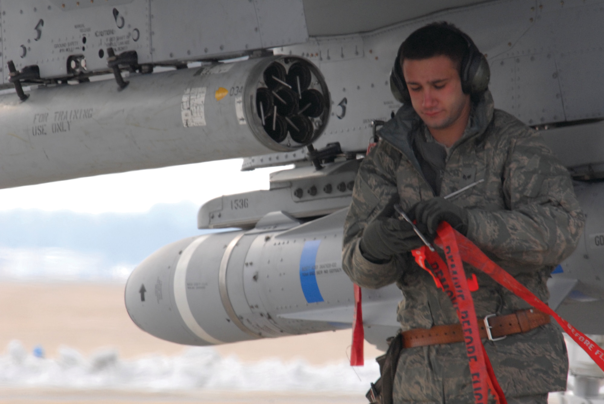 Senior Airman Travis Lewis performs arming functions during an end-of-runway check on one of the 442nd Fighter Wing's three A-10 Thunderbolt II C-model aircraft Dec. 29, 2009. The 442nd Fighter Wing is an Air Force Reserve unit at Whiteman Air Force Base, Mo. (U.S. Air Force photo by Senior Airman Danielle Wolf)