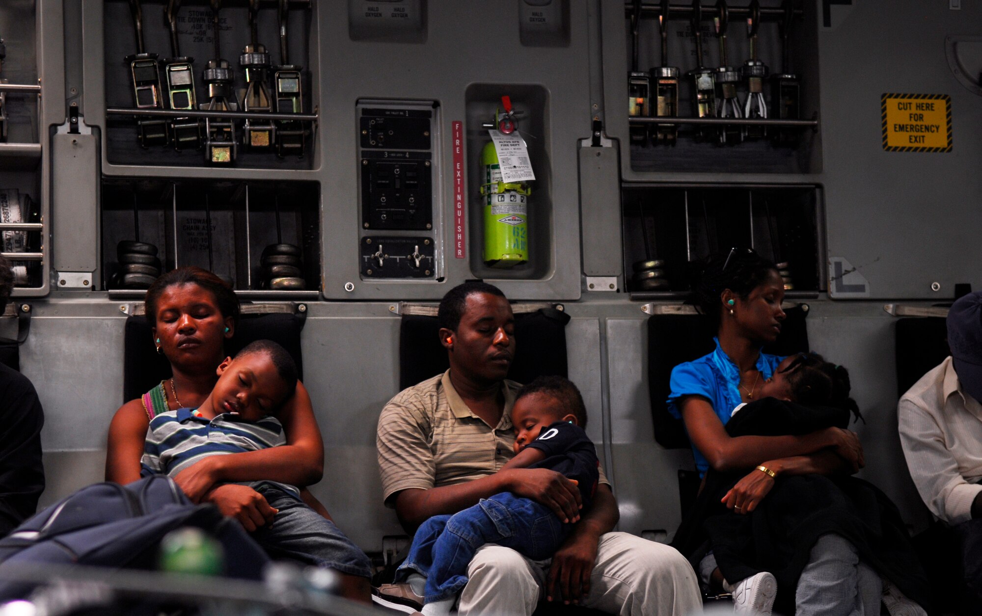 Families sleep aboard a C-17 cargo aircraft enroute to Orlando, Fla., Jan. 19.  After dropping off nearly 100 citizens, the aircraft proceeded back to Pope Air Force Base, N.C., before swapping out aircrews and continuing the air transportation mission all over again.  (U.S. Air Force photo/1st Lt. Matt Schroff)