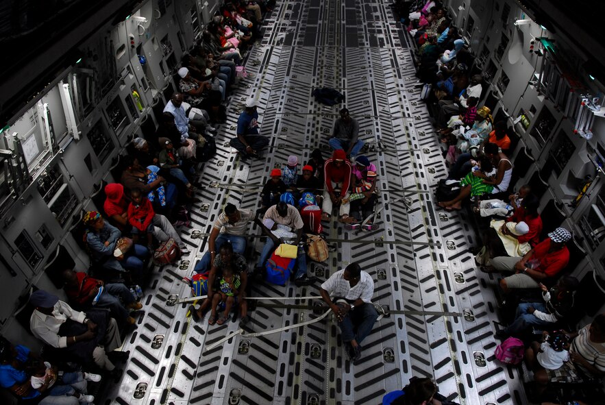 U.S. citizens, mostly women, children and elderly, are evacuated aboard a C-17 cargo aircraft bound for Orlando, Fla., Jan. 19.  Nearly 100 citizens were transported to Orlando International Airport where they were met by members of the Department of Homeland Security and U.S. Customs and Border Protection who provided them with blankets for the slightly cooler night in Orlando.  (U.S. Air Force photo/1st Lt. Matt Schroff)