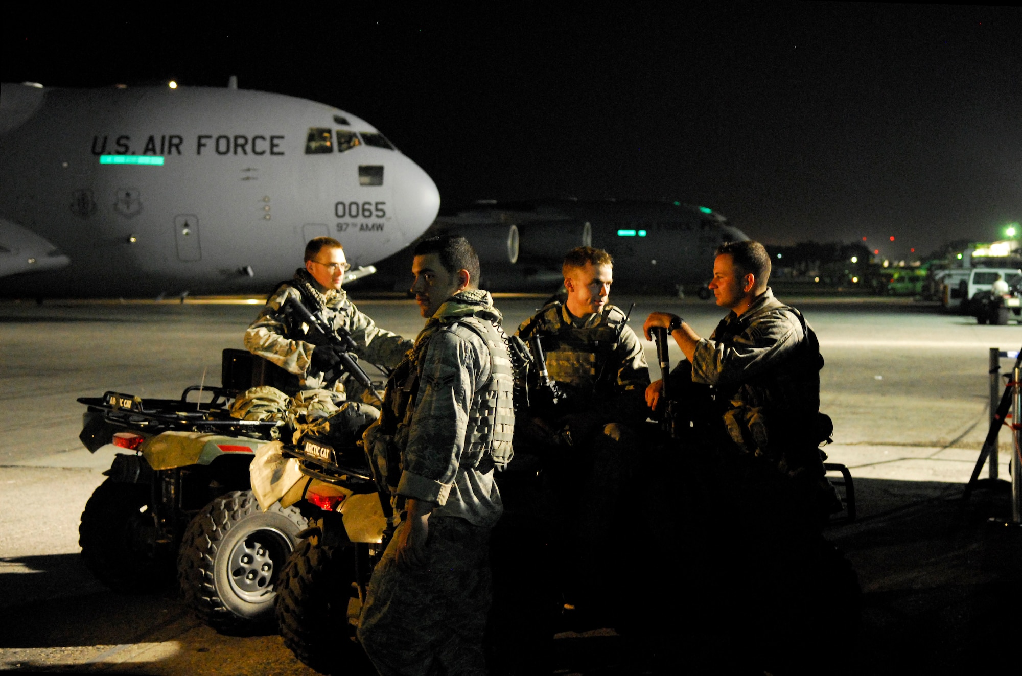 Air Force personnel provide security on the flight line at the Toussaint Louverture International Airport in Port-au-Prince, Haiti, Jan. 19.  In addition to ramp security available on site, incoming Air Force aircraft typically carry a team of specially trained security forces personnel known as “Ravens” who provide security and overwatch during loading and unloading operations.  (U.S. Air Force photo/1st Lt. Matt Schroff)