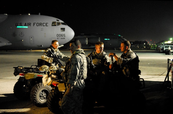 Air Force personnel provide security on the flight line at the Toussaint Louverture International Airport in Port-au-Prince, Haiti, Jan. 19.  In addition to ramp security available on site, incoming Air Force aircraft typically carry a team of specially trained security forces personnel known as “Ravens” who provide security and overwatch during loading and unloading operations.  (U.S. Air Force photo/1st Lt. Matt Schroff)