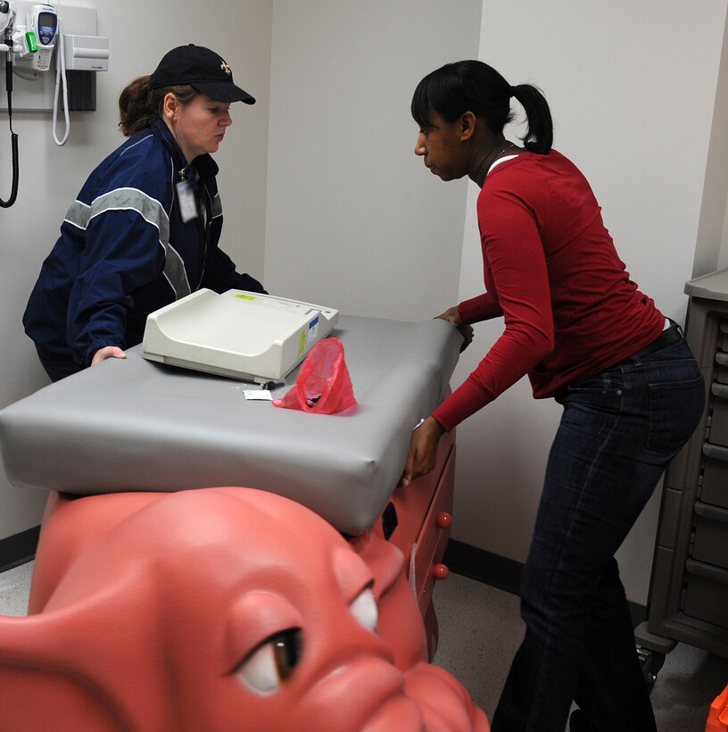 LANGLEY AIR FORCE BASE, Va. -- Staff Sgt. Michelle Pinson and Senior Airman Antonia Harris, 633d Medical Operations Squadron Pediatric Clinic aerospace medical technicians, arrange an exam bed on the first floor of the USAF Langley Hospital addition Jan. 17.  Renovation of the old hospital wing and the main Dental Clinic will begin soon and continue for approximately two years.  (U.S. Air Force photo/Senior Airman Zachary Wolf)
