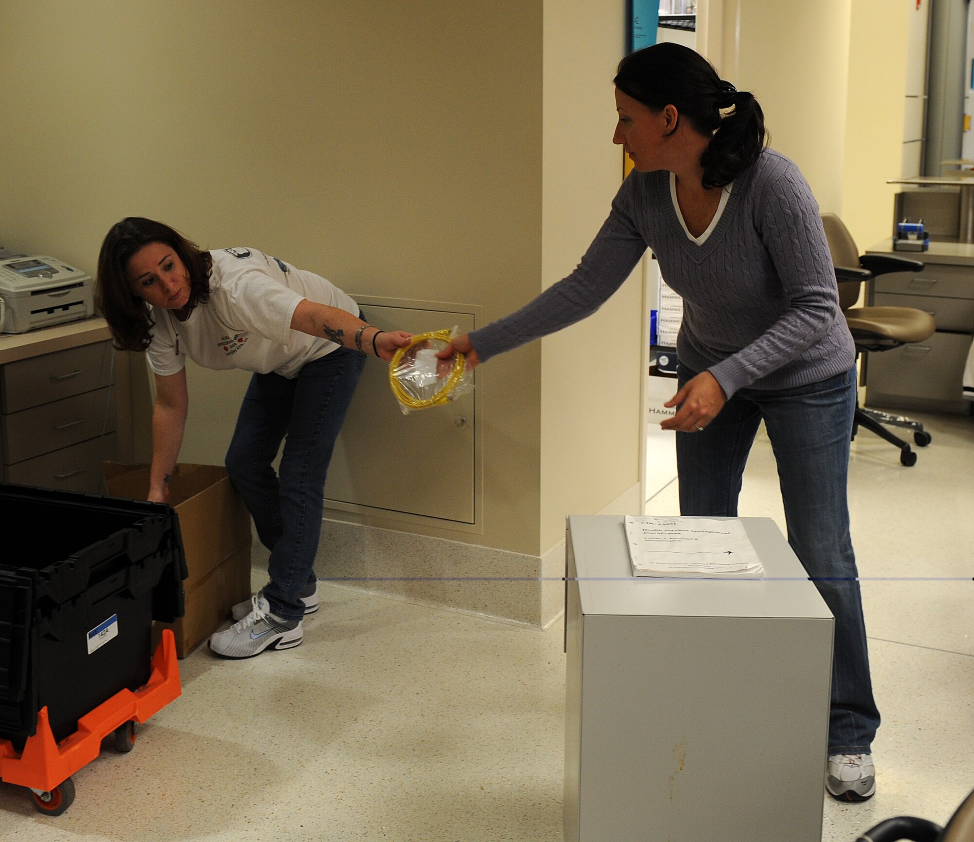 LANGLEY AIR FORCE BASE, Va. -- Tech. Sgts. Michelle Wilkerson, 633d Medical Operations Squadron Pediatric Records noncommissioned officer in charge, and Beverly Harrington, 633d MDOS Pediatric Flight chief, unpack equipment and supplies on the first floor of the USAF Langley Hospital addition Jan. 17.  Renovation of the old hospital wing and the main Dental Clinic will begin soon and continue for approximately two years.  (U.S. Air Force photo/Senior Airman Zachary Wolf)