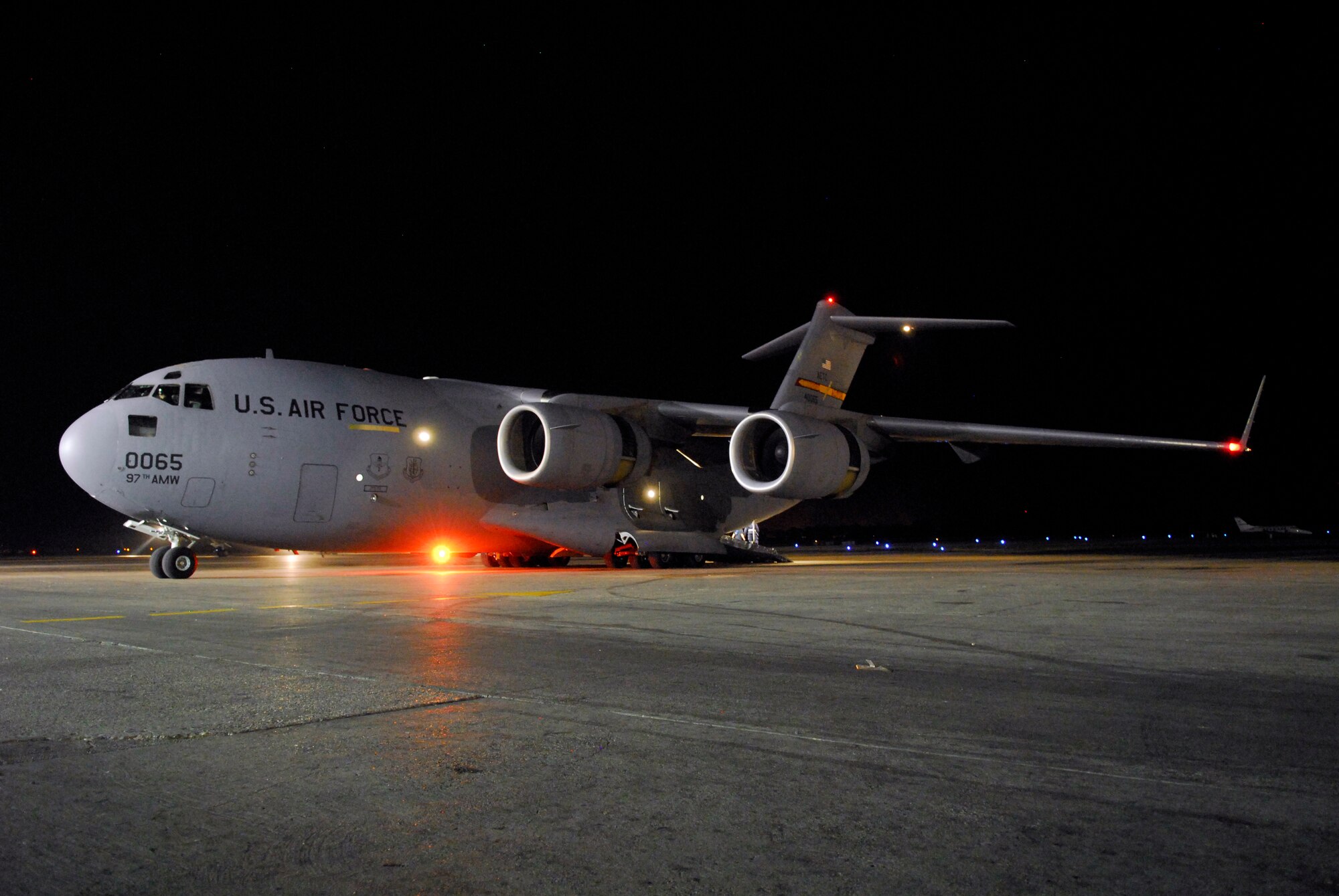 A C-17 cargo aircraft waits to load passengers on the ramp at Port-au-Prince international airport, Jan. 19.  The C-17, commanded by Capt. Harold Kramer of the 58th Airlift Squadron based out of Altus Air Force Base, Oklahoma, was crewed by three pilots with nearly 20,000 flight hours combined experience.   (U.S. Air Force photo/1st Lt. Matt Schroff)