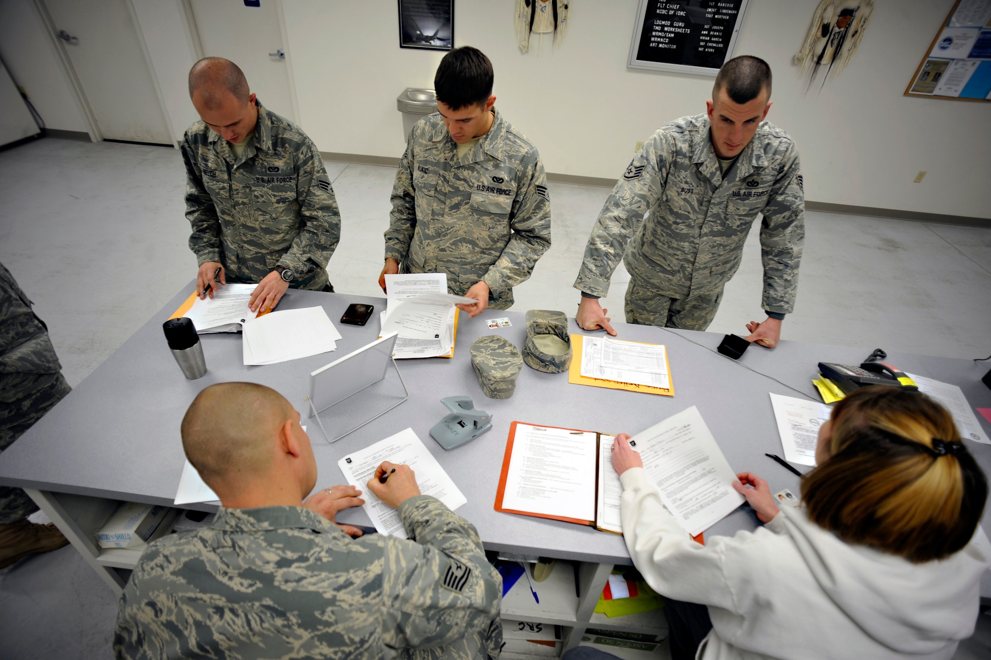 Airmen from the 49th Logistics Readiness Squadron look at mobility folders belonging to Airmen from the 49th Materiel Maintenance Group Jan. 17, 2010, at Holloman Air Force Base, N.M., to ensure they are prepared to deploy to Haiti in support of Operation United Response. The base is preparing tents, generators, air conditioning units, reverse osmosis water purification units, or ROWPUs, and personnel to send to that country after it was rocked by a magnitude 7 earthquake Jan. 12 leaving thousands dead and even more homeless. (U.S. Air Force photo/Staff Sgt. Anthony Nelson)