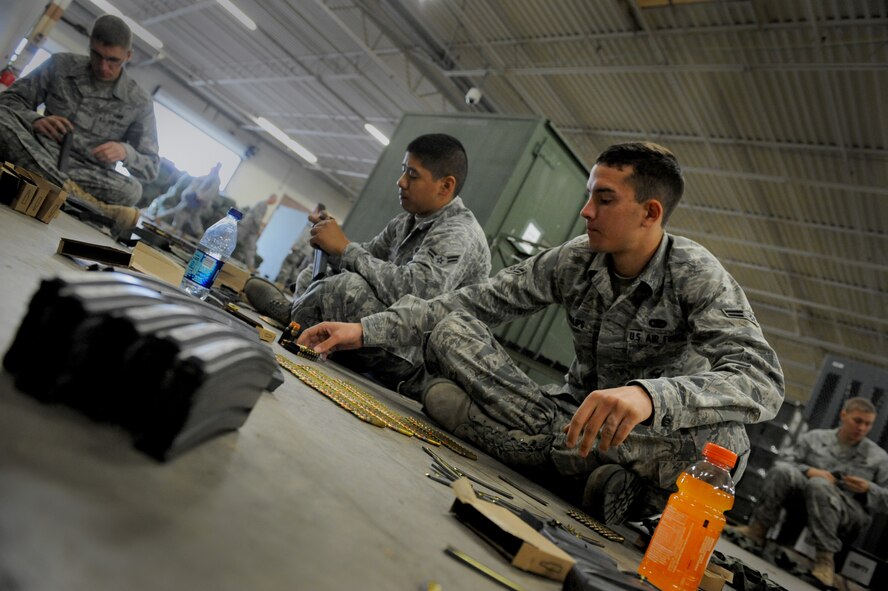 MOODY AIR FORCE BASE, Ga. -- Airman 1st Class Scott Phillips, 824th Security Forces Squadron fire team member, inserts ammunition into magazines in preparation for a short-notice deployment here Jan. 20. Members of the 823rd SFS have been tasked for a deployment to Haiti. (U.S. Air Force photo by Senior Airman Gina Chiaverotti-Paige)