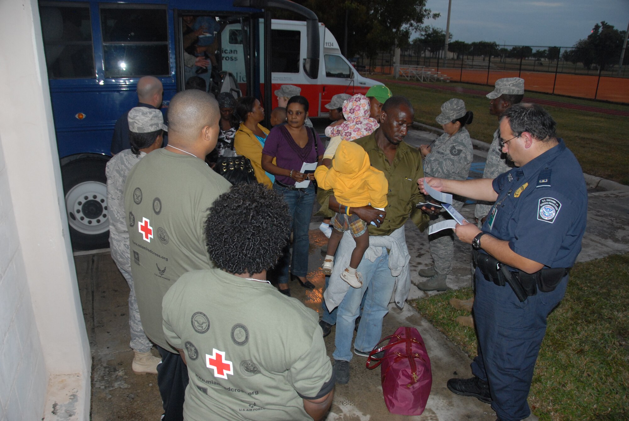 Evacuees from Haiti begin evacuation in-processing at Homestead Air Reserve Base, Fla., Jan. 20,2010. Upon arriving by aircraft, they are bussed to the base fitness center for in-processing.  (Air Force photo/Master Sgt. Chance Babin)