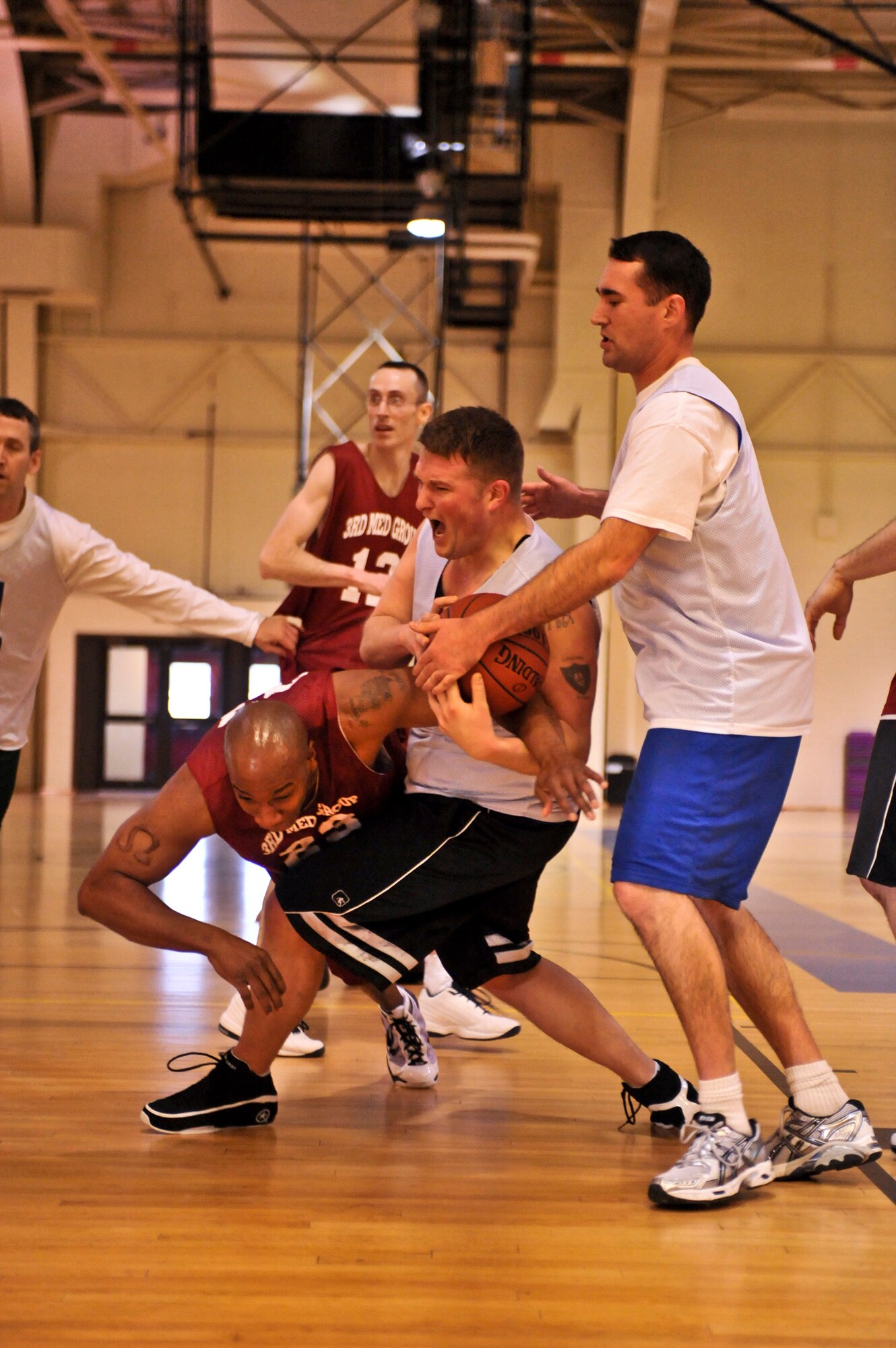 ELMENDORF AIR FORCE BASE, Alaska – The 3rd Force Support Squadron’s Mike Lamb, white, rips the ball from the 3rd Medical Support Squadron’s Kaleth Wright, red, during the over-30 championship basketball game Jan. 19. The 3rd MDSS won two games in a row to take the base championship. (Air Force photo by Airman 1st Class Christopher Gross)