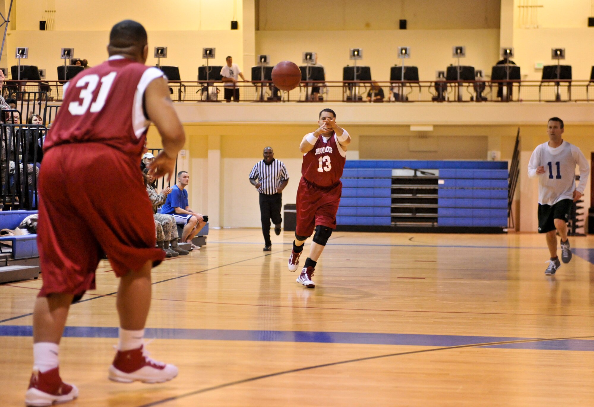 ELMENDORF AIR FORCE BASE, Alaska – The 3rd Medical Support Squadron’s James Anderson, 13, passes the ball to teammate Otis Bell, 31, during the over-30 championship basketball game Jan. 19. The 3rd MDSS won two games in a row against the 3rd Force Support Squadron to take the base championship. (Air Force photo by Airman 1st Class Christopher Gross) 