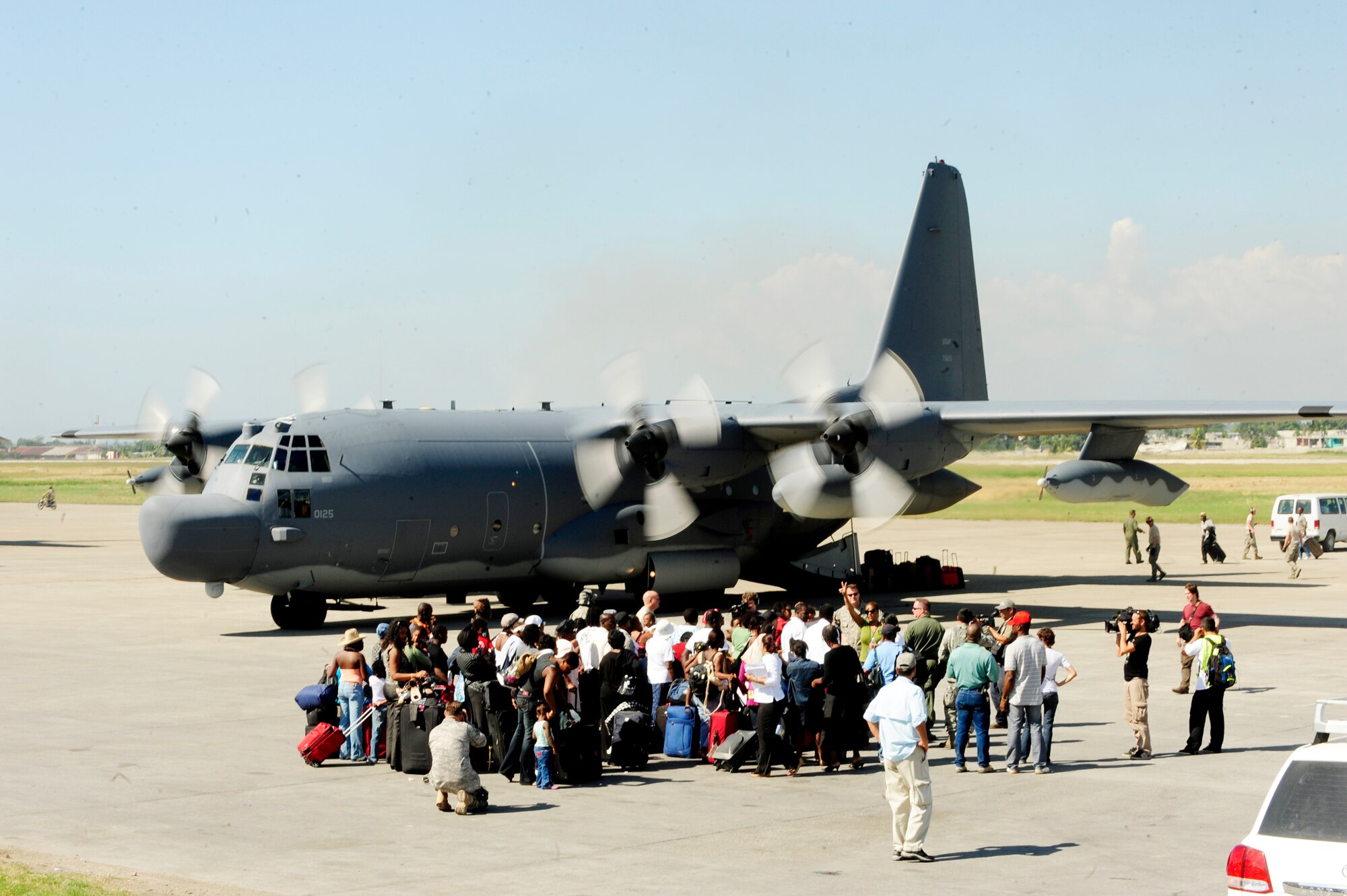 U.S. citizens living in Haiti wait to board a C-130 Hercules that will transport them back to the U.S. Jan. 15, 2010, at the Port-Au-Prince airport, Haiti. Department of Defense assets have been dispatched to Haiti to assist with humanitarian assistance and disaster relief after a magnitude 7 earthquake hit the country Jan. 12, 2010. (U.S. Air Force photo/Tech. Sgt. James L. Harper Jr.)
