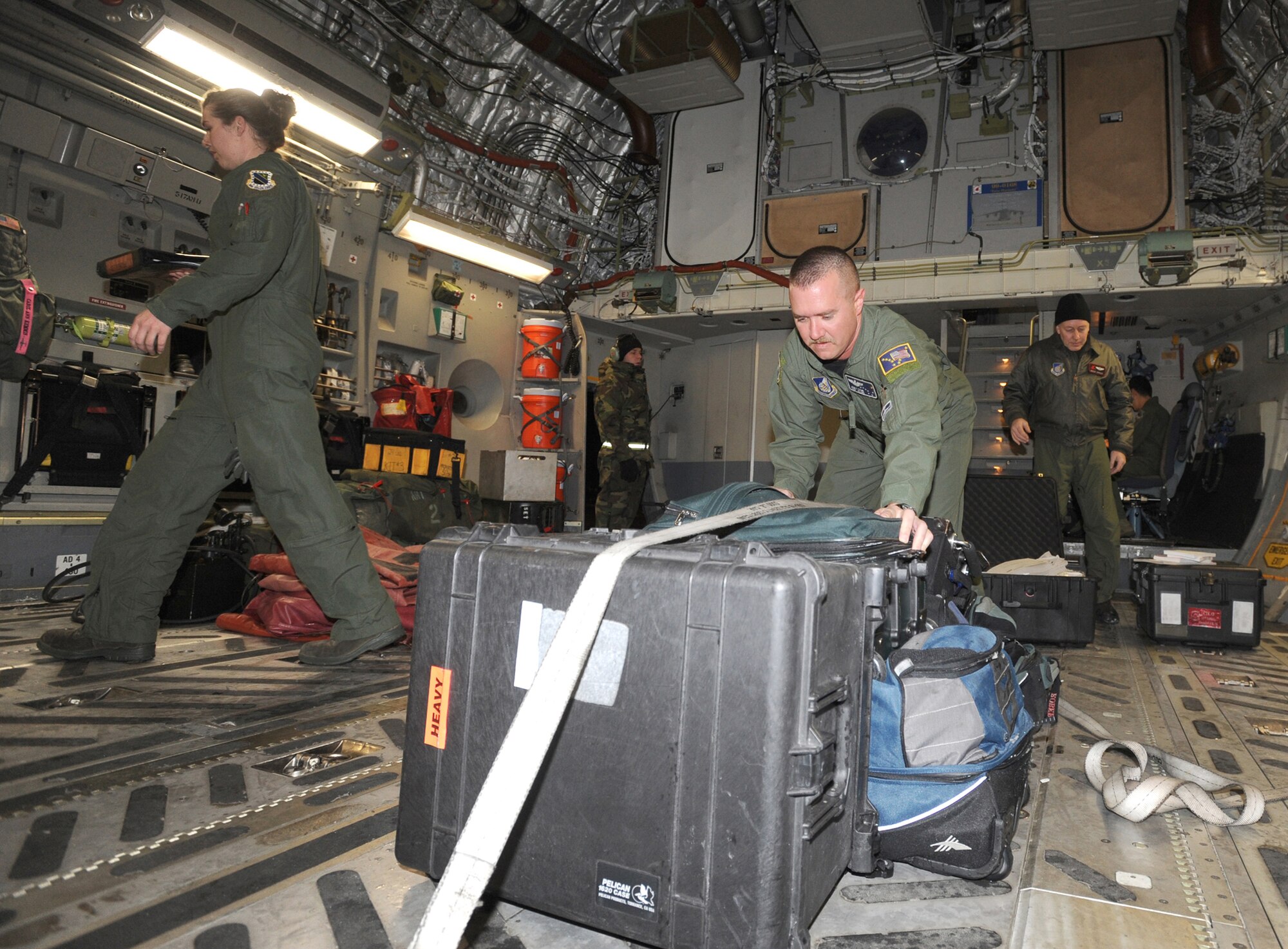 ELMENDORF AIR FORCE BASE, Alaska -- Aircrew members from the 517th Airlift Squadron and 249th Airlift Squadron scramble to deploy to Haiti hours after being notified Jan. 19. The crewmembers will assist humanitarian efforts for the earthquake victims in Haiti. (Air Force photo by Senior Airman Laura Turner)