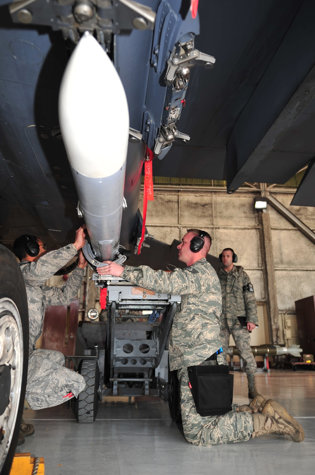 Airmen from the 334th Aircraft Maintenance Squadron load an AIM-120 munition onto an F-15E Strike Eagle during a load crew competition on Seymour Johnson Air Force Base, N.C., Jan. 15, 2010. Unlike previous competitions, all the teams competed at the same time testing their speed against one another. (U.S. Air Force photo/Airman 1st Class Rae Perry)
