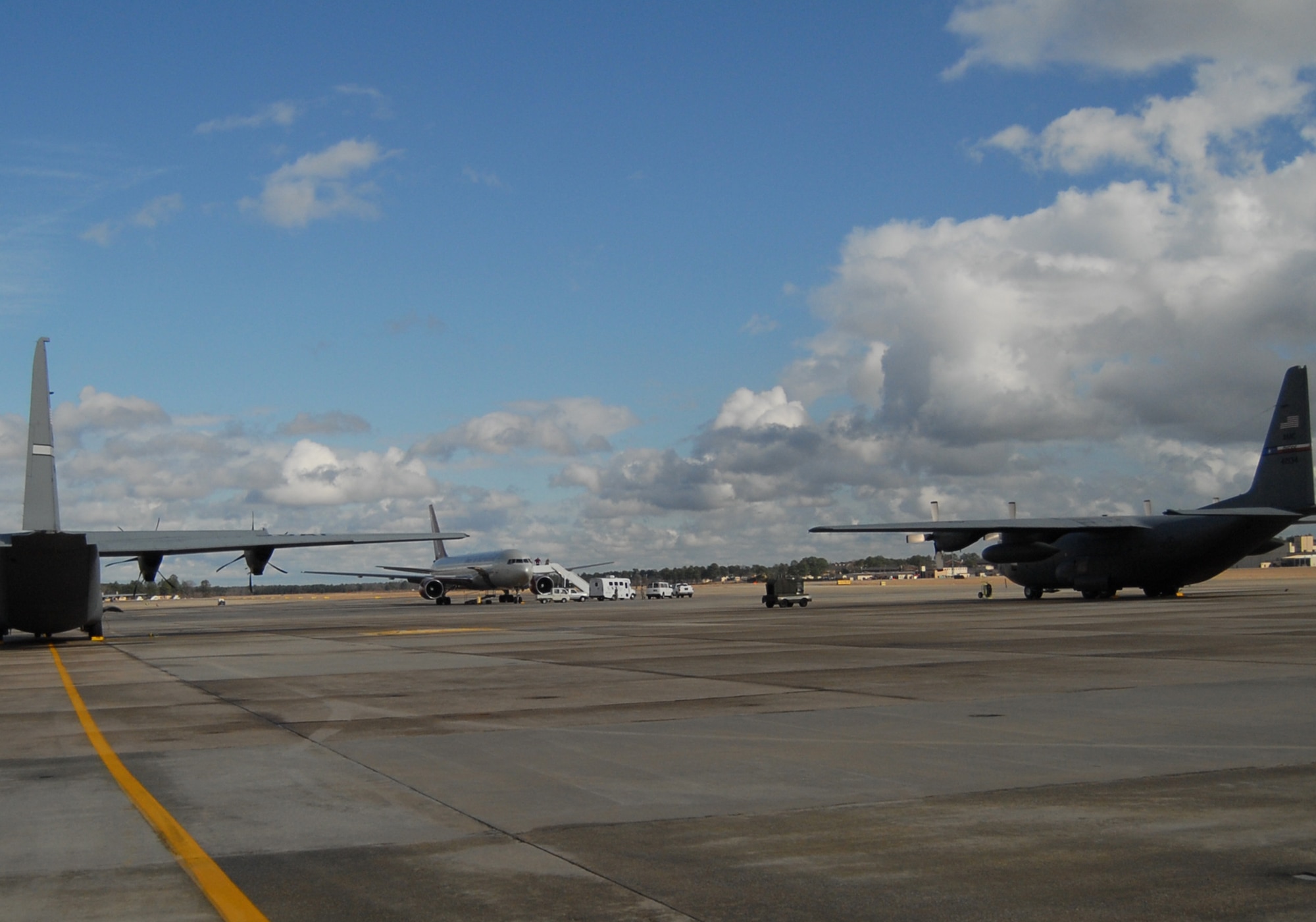A commercial aircraft sits among Air Force C-130 and C-17 aircraft on Pope’s airfield. The aircraft will be loaded with supplies, equipment and personnel to be sent to Haiti in support of relief efforts after a 7.0 earthquake devastated the island nation Jan. 12. Popes airfield is being used as a staging ground for airlift operations, both military and civilian, into Haiti. (U.S. Air Force photo/Senior Airman Kris Levasseur)