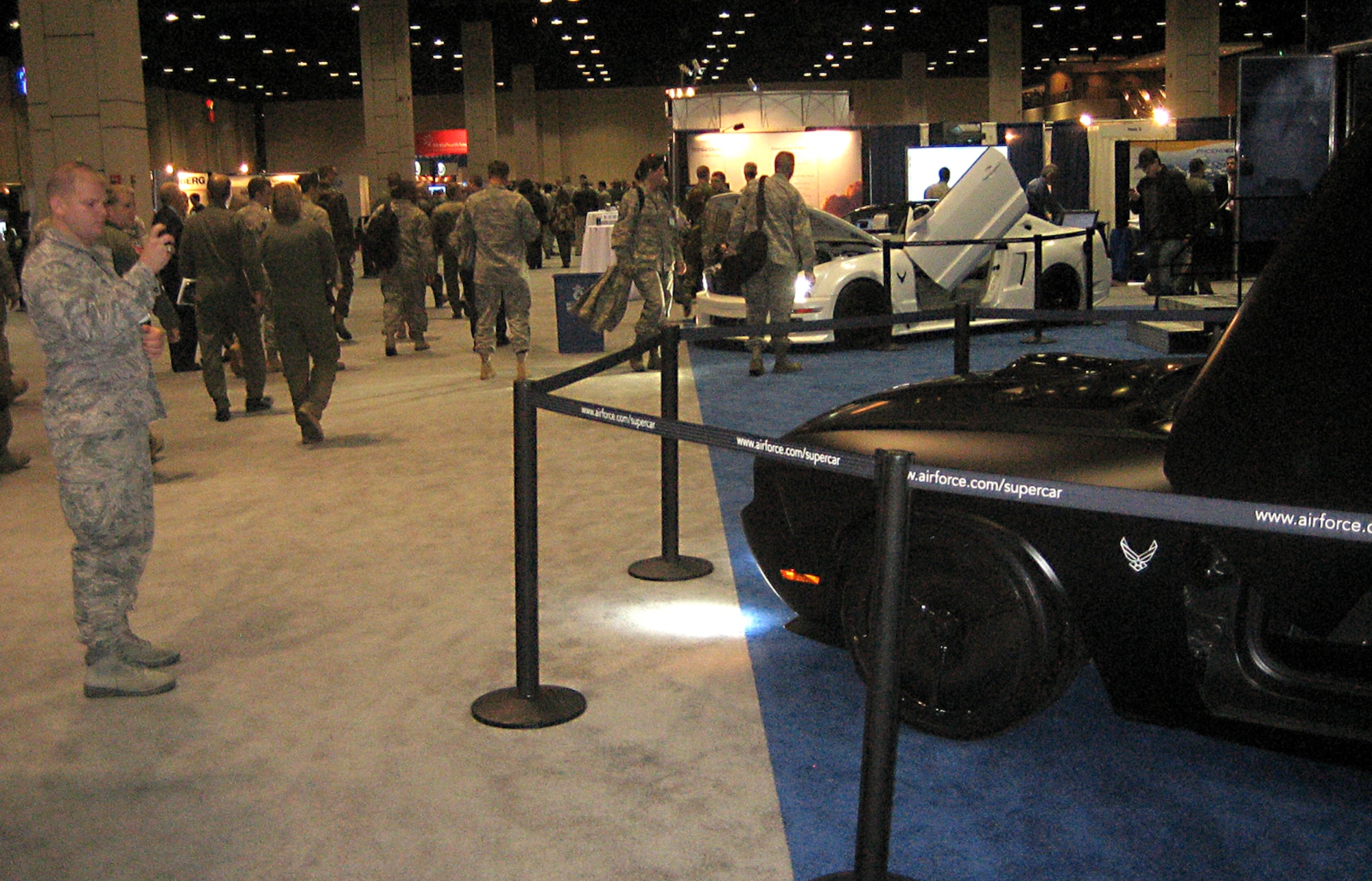 Second Lt. Chase Carter, 81st Comptroller Squadron, takes a photo of the Air Force Dodge Challenger at the technology exhibit at the Air Education and Training Command Symposium, Jan. 14-15 at the Henry B. Gonzalez Convention Center in San Antonio.  More than 100 exhibits featured booths from various bases and commercial vendors.  Keesler and 2nd Air Force sent 160 members to the conference.   (U.S. Air Force photo by 1st Lt. Joost Verduyn)
