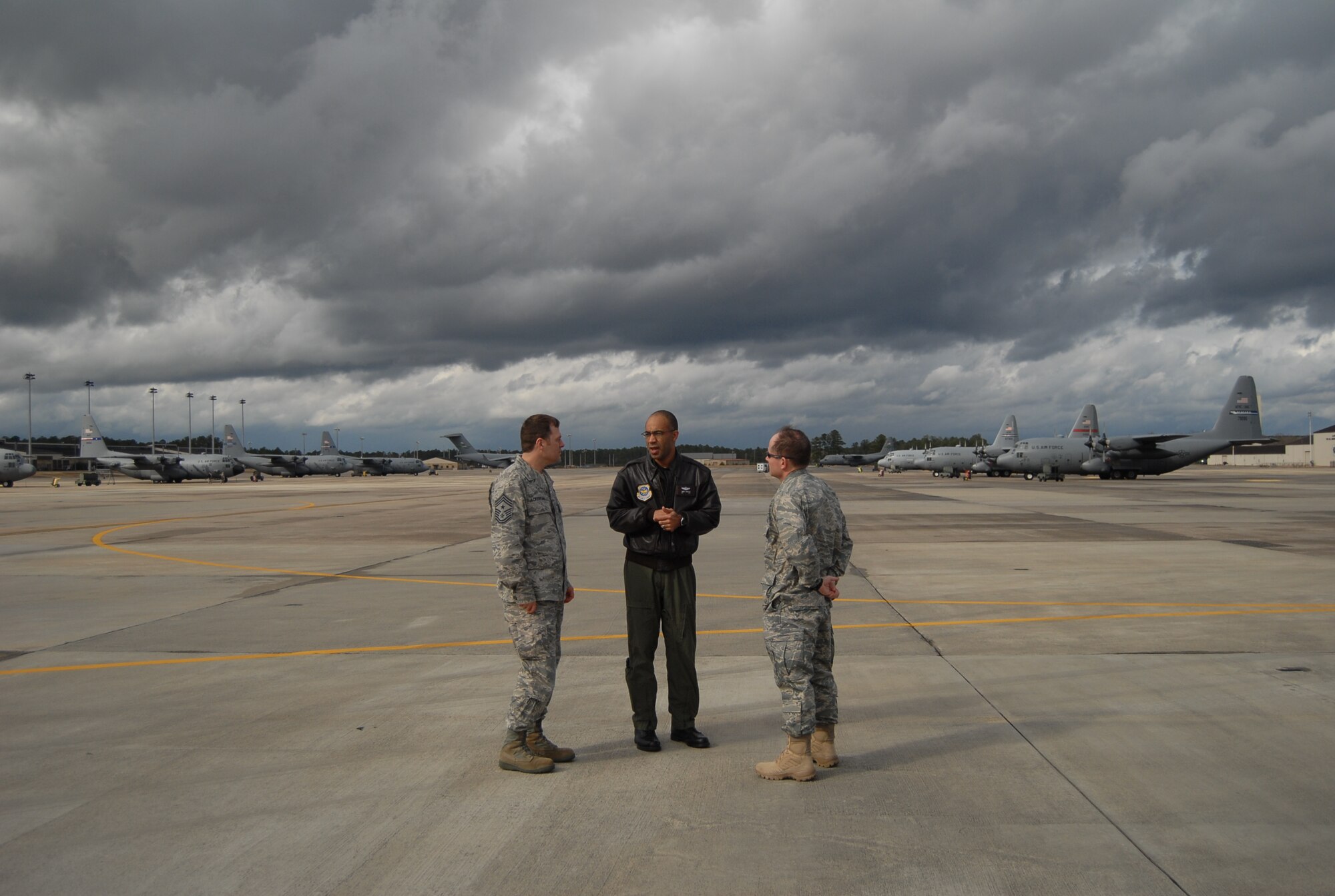 Col. James Johnson, 43rd Airlift Wing Commander (middle), Col. Craig Berlette, 43rd AW Vice Commander (Right) and Chief Master Sgt. Douglas Ackerman, 43rd AW Command Chief Master Sergeant, discuss airfield operations in front of aircraft from various Air Force active-duty, Guard and Reserve wings on Pope’s airfield Jan. 17. The aircraft will be loaded with supplies, equipment and personnel to be sent to Haiti in support of relief efforts after a 7.0 earthquake devastated the island nation Jan. 12. Popes airfield is being used as a staging ground for airlift operations, both military and civilian, into Haiti. (U.S. Air Force photo/Senior Airman Kris Levasseur)
