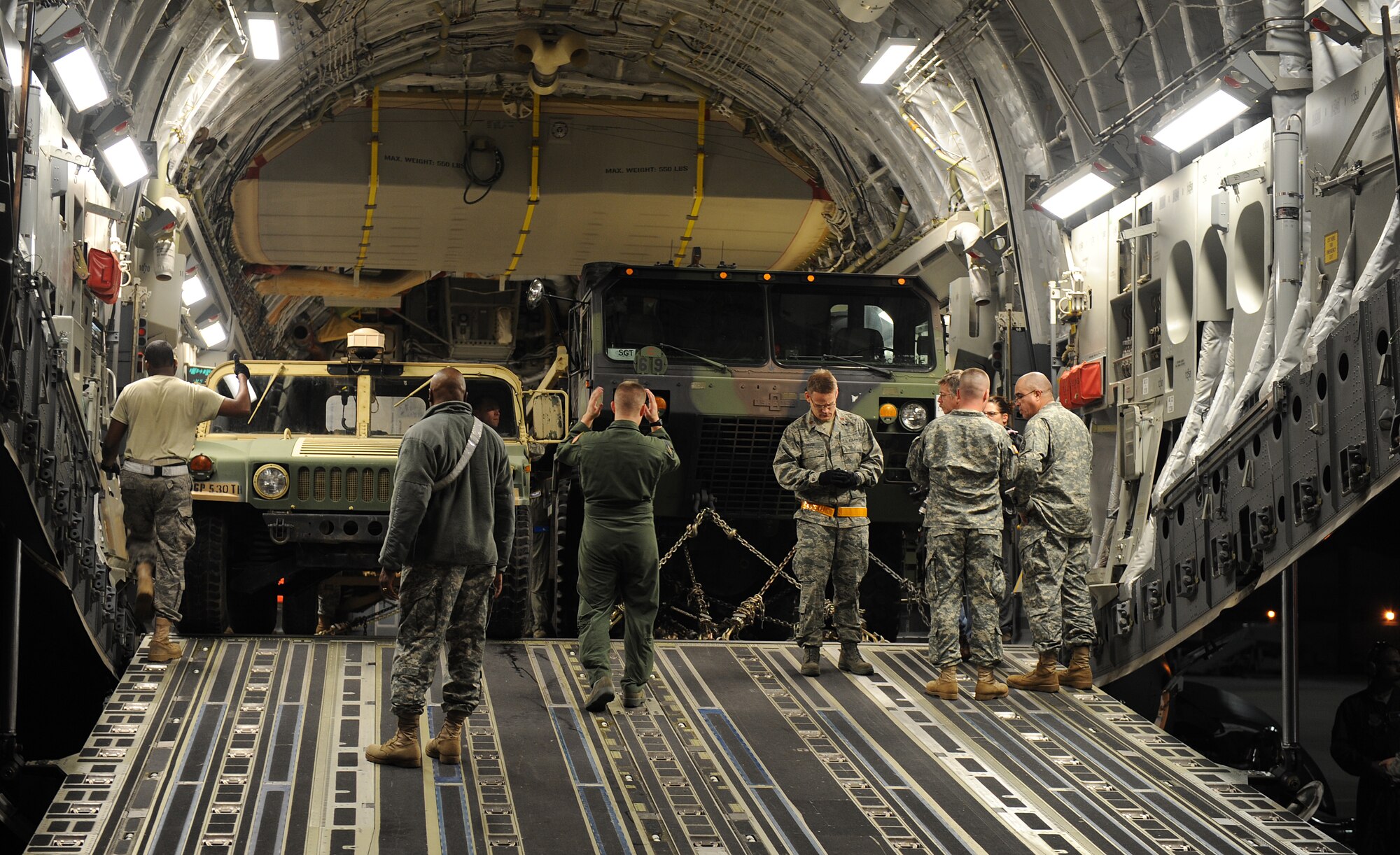 LANGLEY AIR FORCE BASE, Va. -- Air Force and Army personnel load a High Mobility Multipurpose Wheeled Vehicle from the 49th Quartermaster Group, Mortuary Affairs, Ft. Lee, Va., into a C-17 Globemaster III from 436th Airlift Wing, Dover Air Force Base, Del., Jan. 19.  Personnel from Langley and Fort Eustis worked together to load the C-17 as part Operation Unified Response to aid Haiti after the earthquakes. (U.S. Air Force photo/Senior Airman Zachary Wolf)
