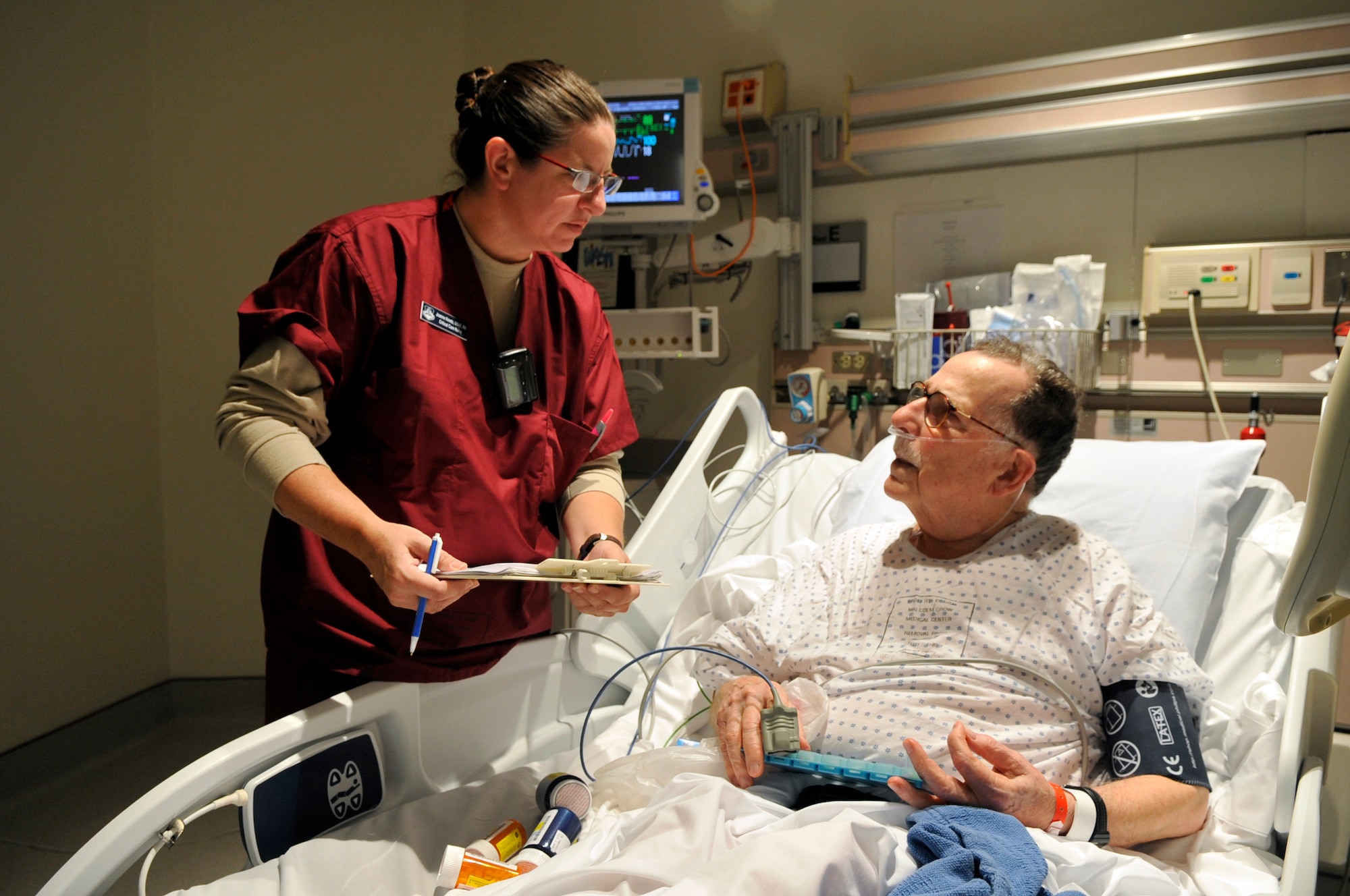 Capt. JoAnne Kmetz, a critical care nurse with the 779th Medical Operations Squadron, does medicine reconciliation with Maj. (ret) Joseph Cooke in the Intensive Care Unit at Malcolm Grow Medical Center at Andrews Air Force Base, Md. on Oct. 5, 2009. ICU nurses like Captain Kmetz will be backfilling for Bethesda National Naval Medical Center nurses deployed on the USNS Comfort, a naval hospital ship providing medical relief to victims of the recent earthquake in Haiti. (U.S. Air Force photo by Staff Sgt. Renae L. Kleckner)