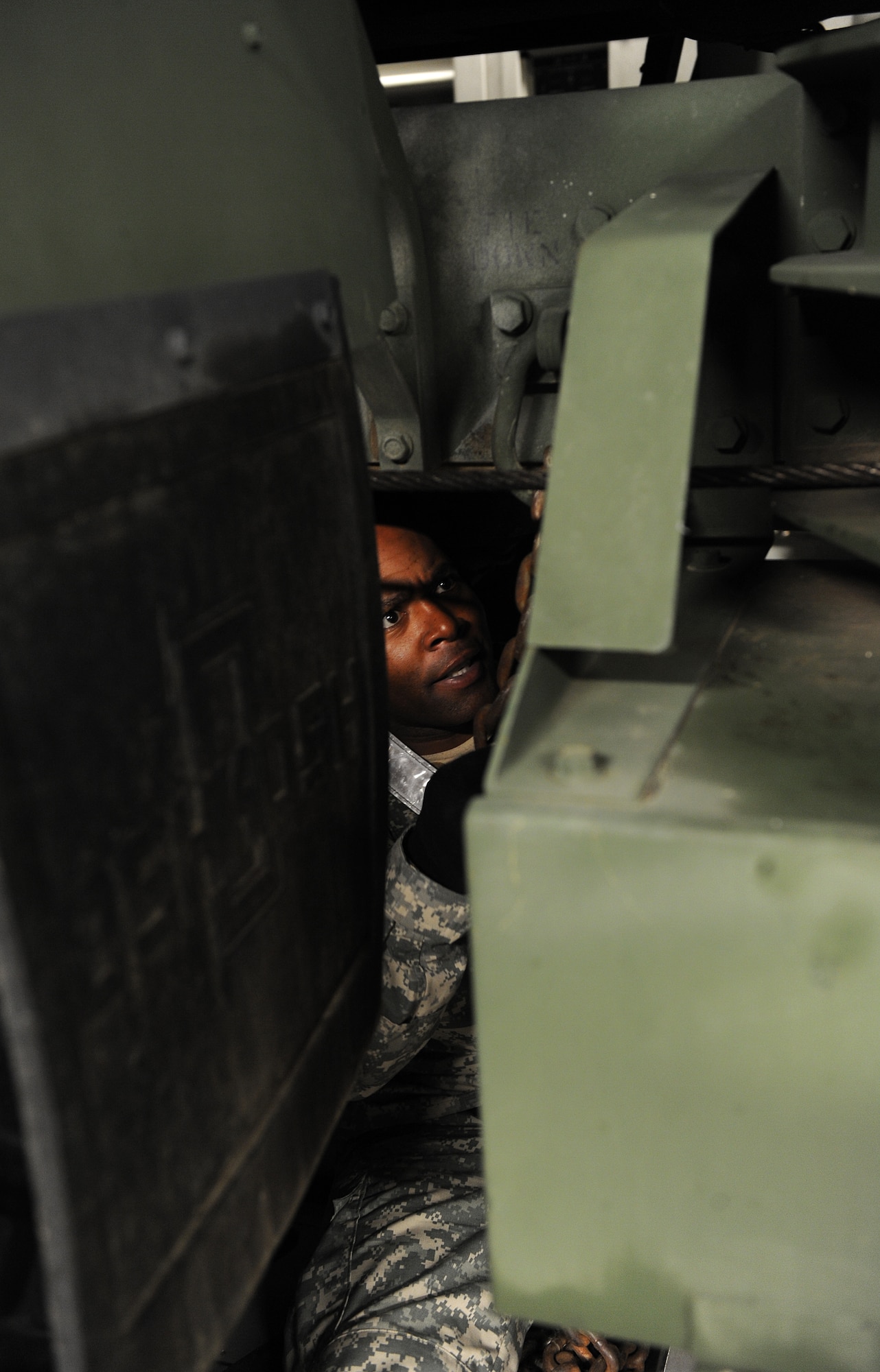 LANGLEY AIR FORCE BASE, Va. -- U.S. Army Sgt. Ronald Cooper, Headquarters Detachment 24 cargo specialist, secures an M1120 Heavy Expanded Mobility Tactical Truck Load Handling System in the C-17 Globemaster III from the 436th Airlift Wing, Dover Air Force Base, Del., Jan. 19.  Personnel from Langley and Fort Eustis worked together to load the C-17 as part Operation Unified Response to aid Haiti after the earthquakes. (U.S. Air Force photo/Senior Airman Zachary Wolf)
