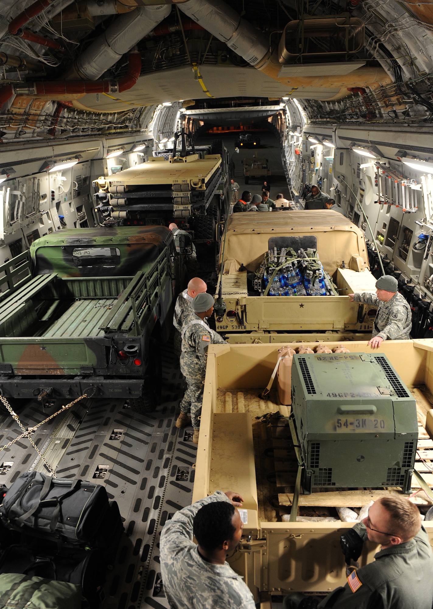 LANGLEY AIR FORCE BASE, Va. --  Personnel from Langley and Fort Eustis work together to load a C-17 Globemaster III from the 436th Airlift Wing, Dover Air Force Base, Del., Jan. 19. This was part of Operation Unified Response to aid Haiti after the earthquakes. (U.S. Air Force photo/Senior Airman Zachary Wolf)
