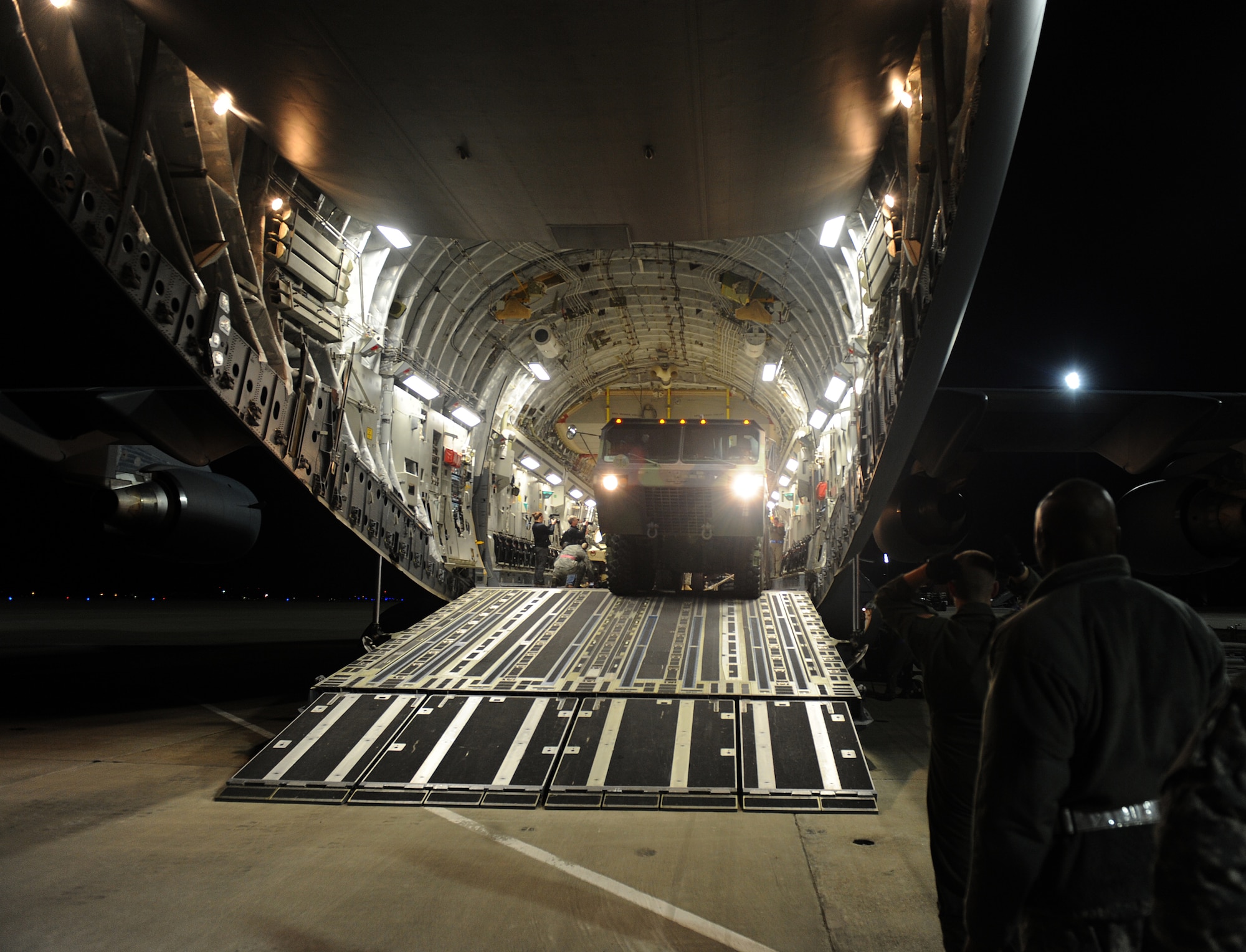 LANGLEY AIR FORCE BASE, Va. -- An M1120 Heavy Expanded Mobility Tactical Truck Load Handling System backs into a C-17 Globemaster III from the 436th Airlift Wing, Dover Air Force Base, Del. Jan. 19.  Personnel from Langley and U.S. Army Fort Eustis worked together to load the C-17 as part Operation Unified Response to aid Haiti after the earthquakes. (U.S. Air Force photo/Senior Airman Zachary Wolf)
