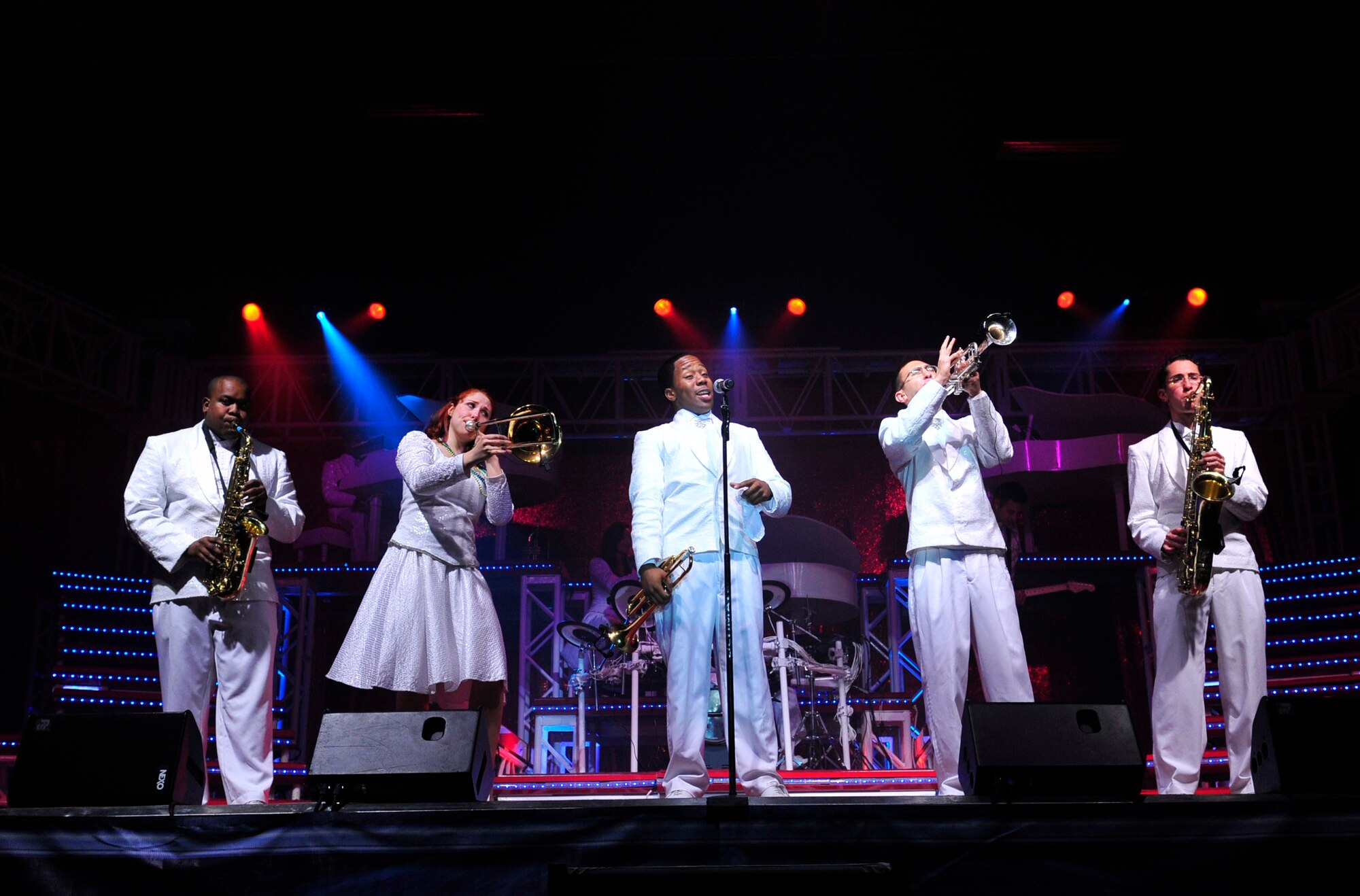 Tops in Blue performers (from left) Senior Airman Tigh Lewis, saxophone, Senior Airman Victoria Howard, trombone, Senior Airman Anthoney Williams, trumpet and vocalist, 1st Lt. Joshua Frilling, trumpet, and Senior Airman Simon Lahn, saxophone, reenact Louis Armstrong's "When the Saints Go Marching In" during the Tops in Blue concert on base Jan. 14. (U.S. Air Force photo by Airman 1st Class Lausanne Pacheco)