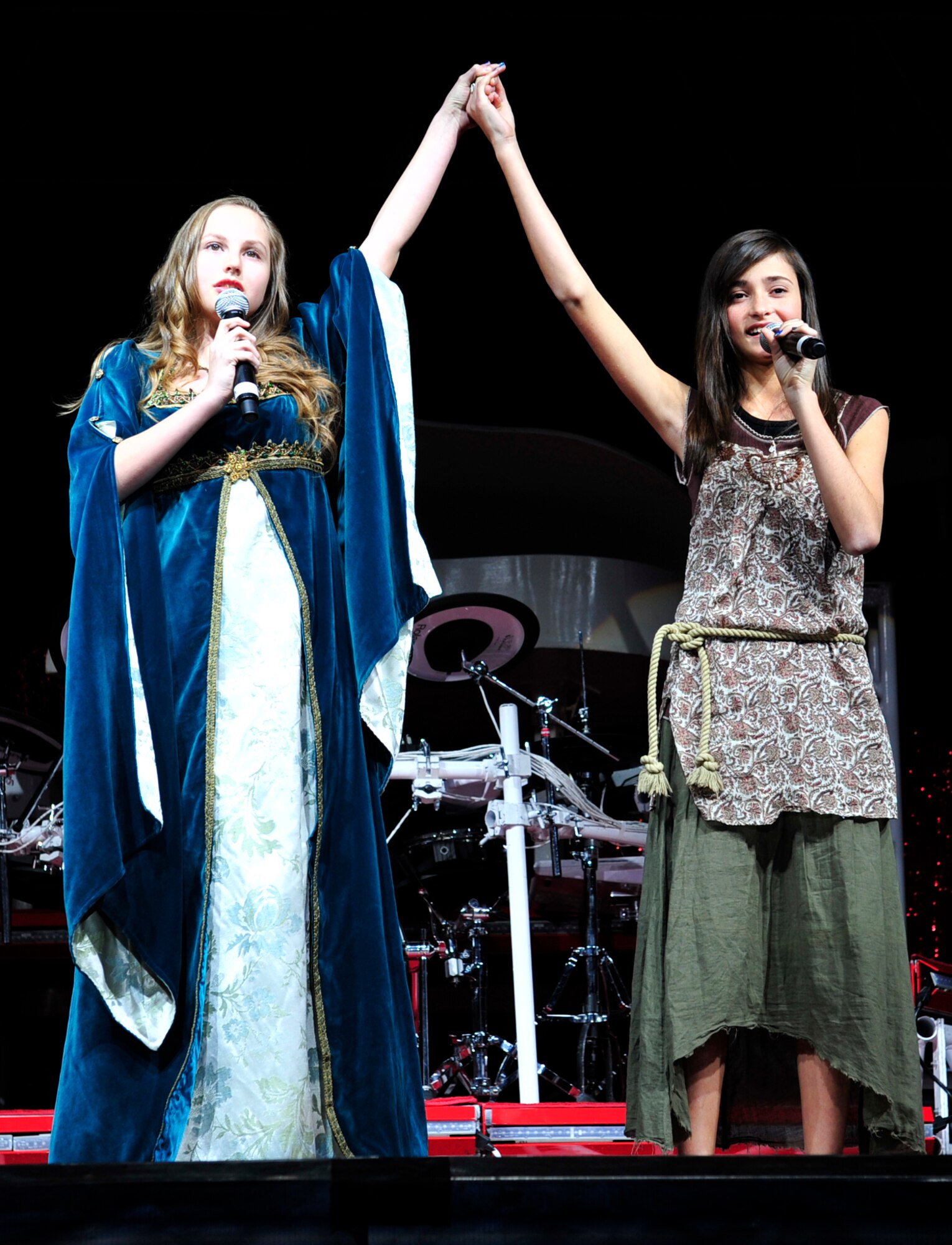 Diana Risse, 12, daughter of Mrs. Janis and Col. George Risse, 19th Mission Support Group commander, and Madison Turcotte, 12, daughter of Mrs. Callie and Chief Master Sgt. Richard Turcotte, 314th Airlift Wing command chief, sing a duet to open the Tops in Blue concert on base Jan. 14. The two won the Air Force-level Family and Teen Talent competition as a duet for their age group. As part of their prize package, they were awarded the opportunity to perform with the Air Force Tops in Blue troupe during their show on base. (U.S. Air Force photo by Airman 1st Class Lausanne Pacheco)