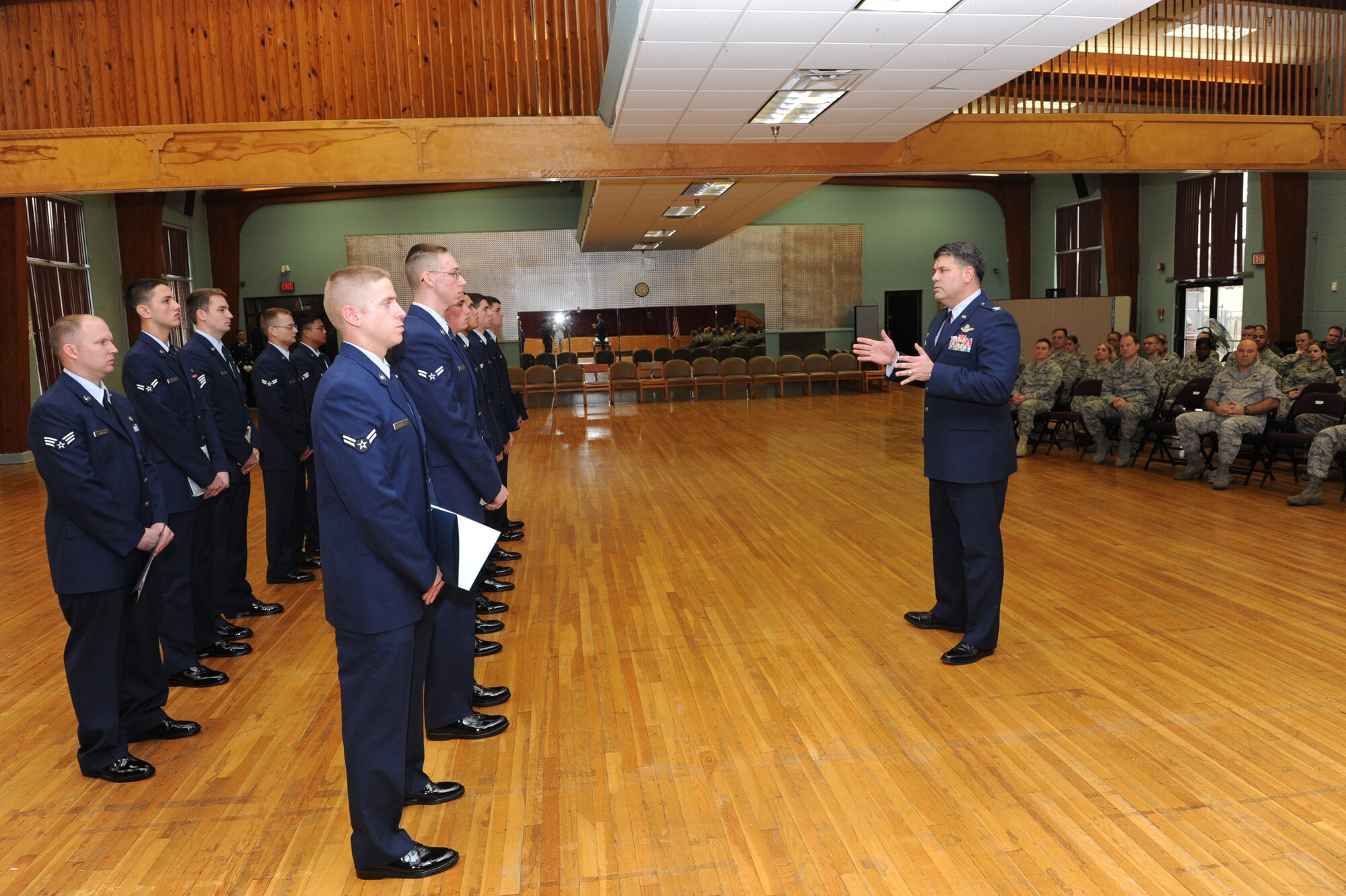 Col. Greg Otey, 19th Airlift Wing commander, congratulates the base’s newest Honor Guard graduates Jan. 19 at the Thomas Community Activity Center for their completion of training. The Little Rock Air Force Base Honor Guard mission is to provide military honors for deserving veterans, retirees, active duty, Guard and Reserve members on base, in Arkansas and the surrounding area on behalf of the president of the United States, the department of the Air Force and a grateful nation. (U.S. Air Force photo by Senior Airman Ethan Morgan)