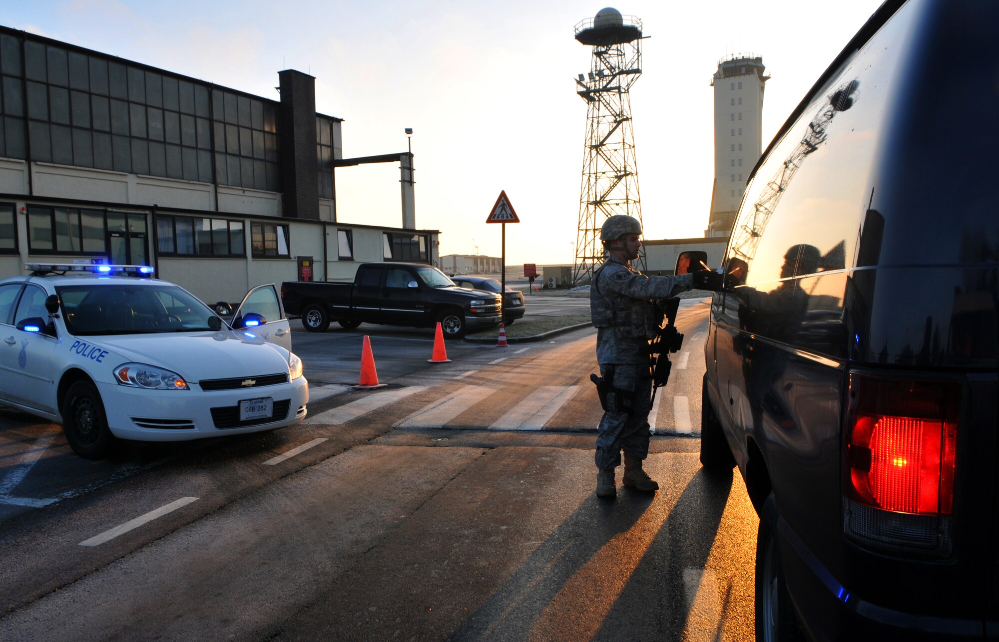 SPANGDAHLEM AIR BASE, Germany -- Airman 1st Class Rick Arend, 52nd Security Forces Squadron, checks ID cards while patrolling an entry control point for a restricted area Jan. 20. Members who have the proper identification are only authorized to enter a restricted area through an ECP. (U.S. Air Force photo/Airman 1st Class Nick Wilson)